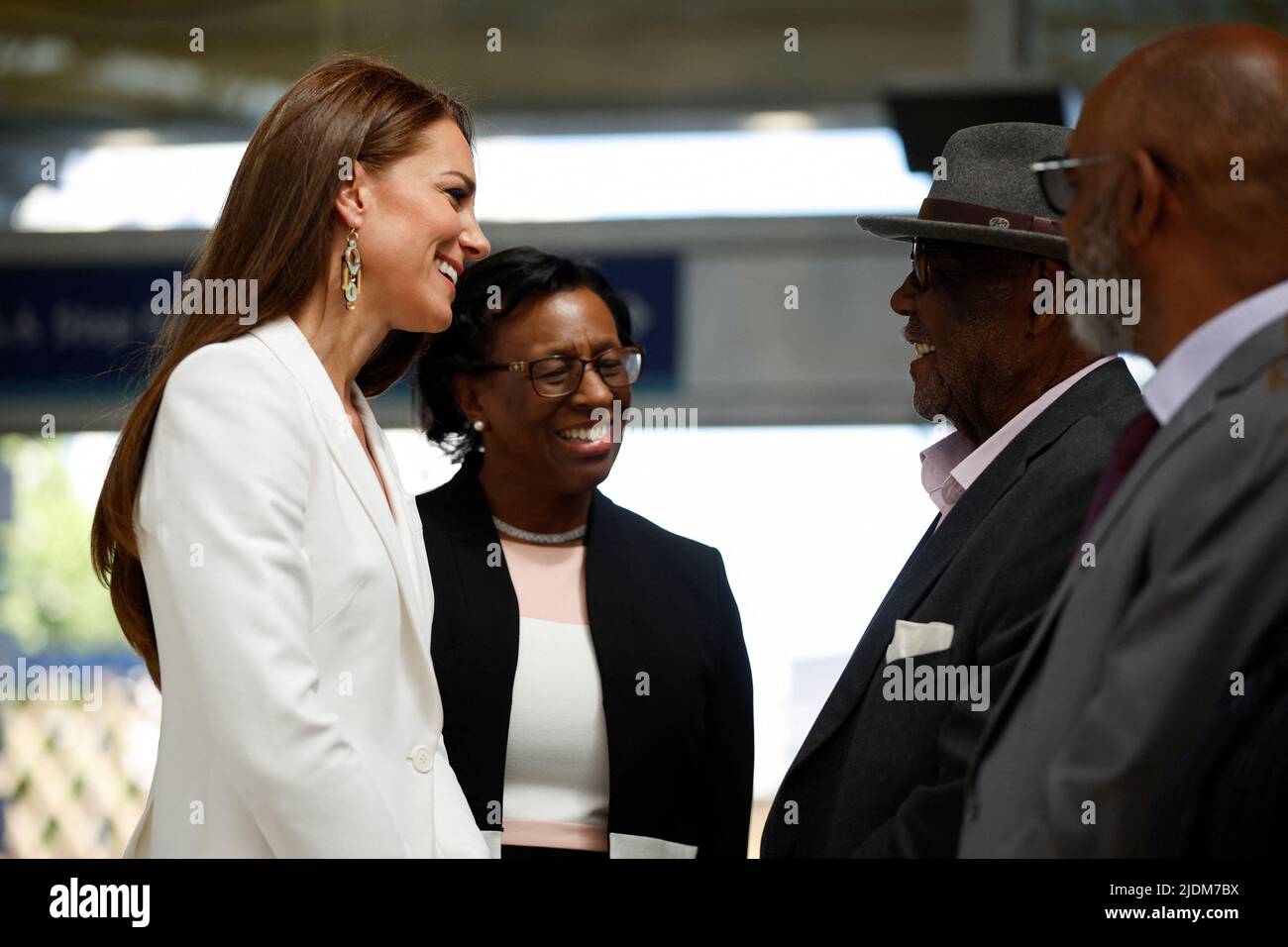The Duchess of Cambridge speaks with Windrush passenger John Richards at the unveiling of the National Windrush Monument at Waterloo Station, to mark Windrush Day. The statue - of a man, woman and child in their Sunday best standing on top of suitcases - was designed by the Jamaican artist and sculptor Basil Watson. Picture date: Wednesday June 22, 2022. Stock Photo
