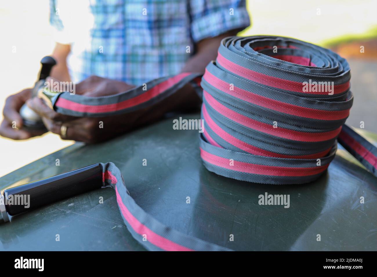 A close-up of a red and black water hose Stock Photo