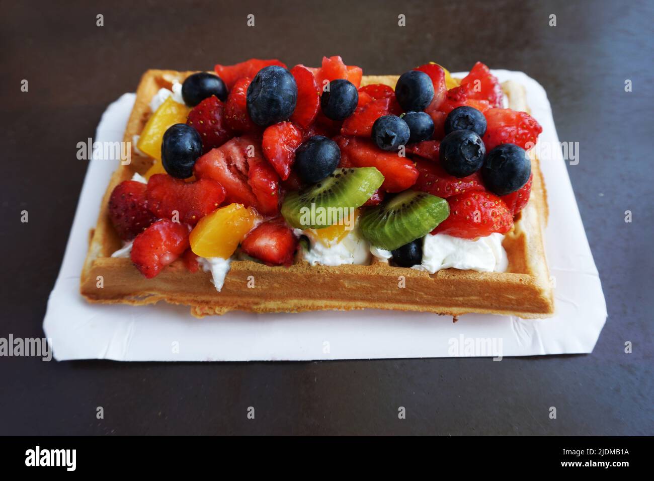 Waffle with whipped cream and fruits Stock Photo - Alamy