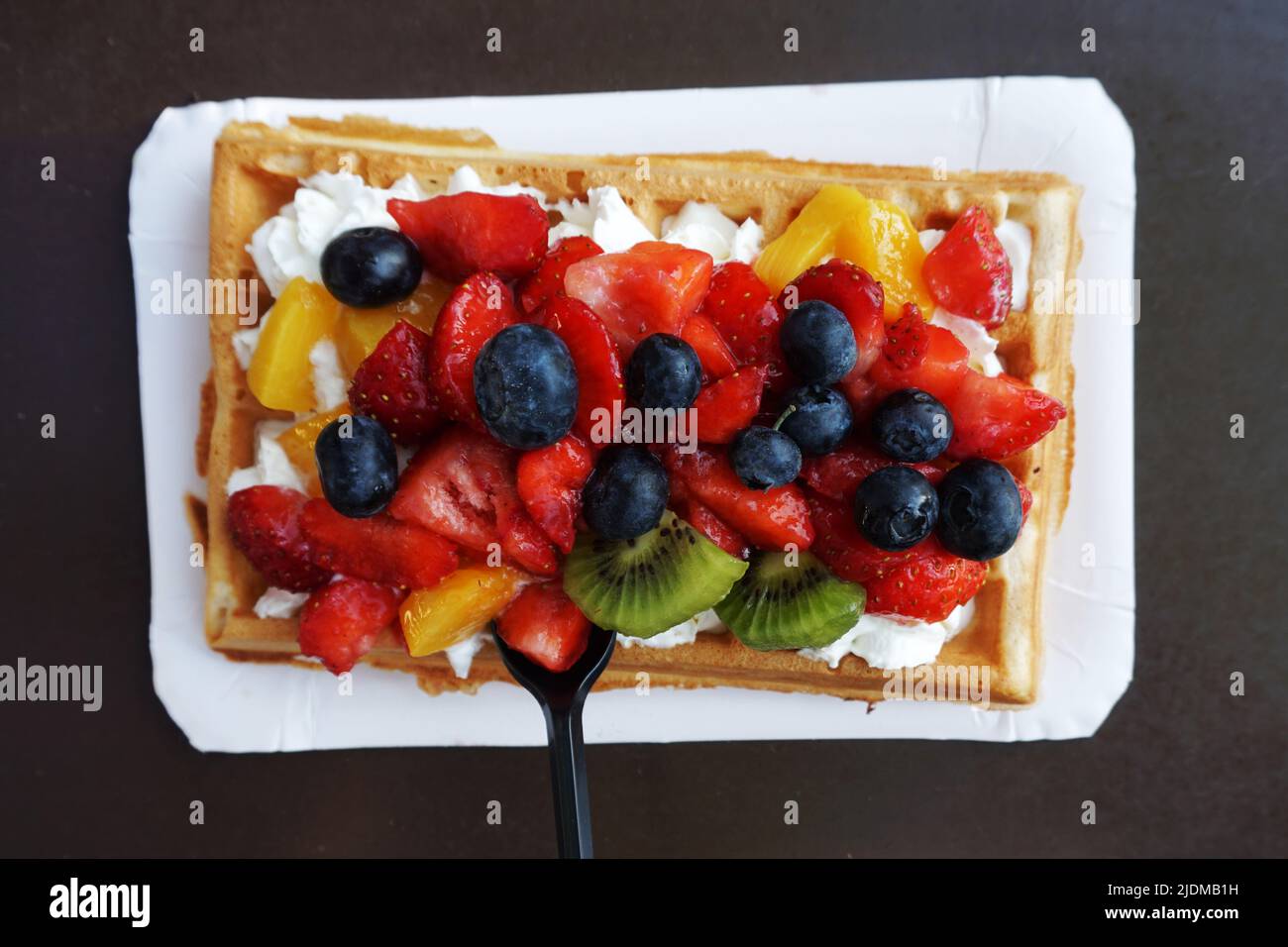Waffle with whipped cream and fruits Stock Photo - Alamy
