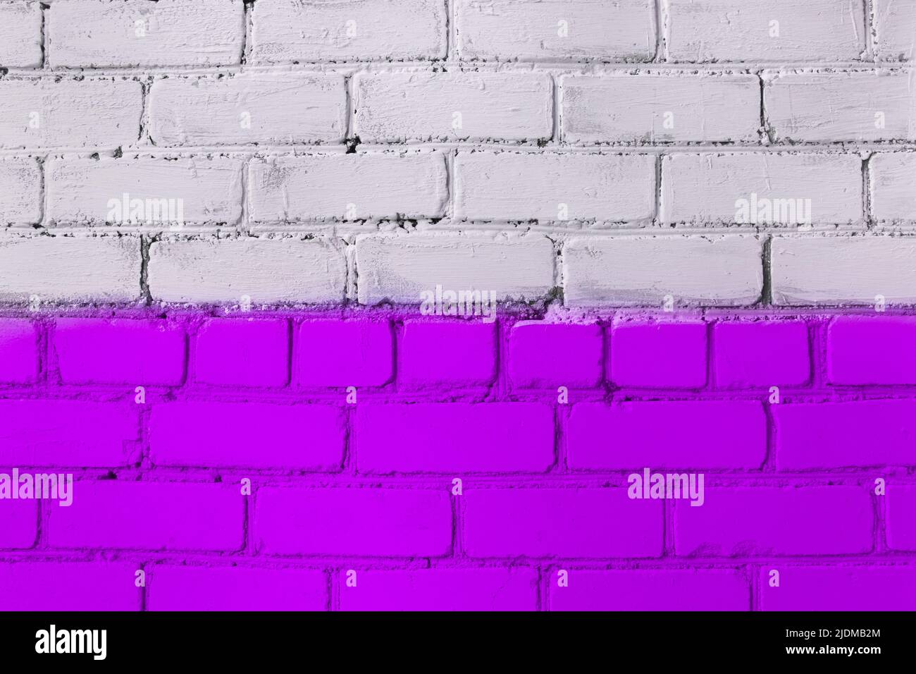 Brick wall paint two colors purple and lilac or violet and white abstract urban background design art texture. Stock Photo
