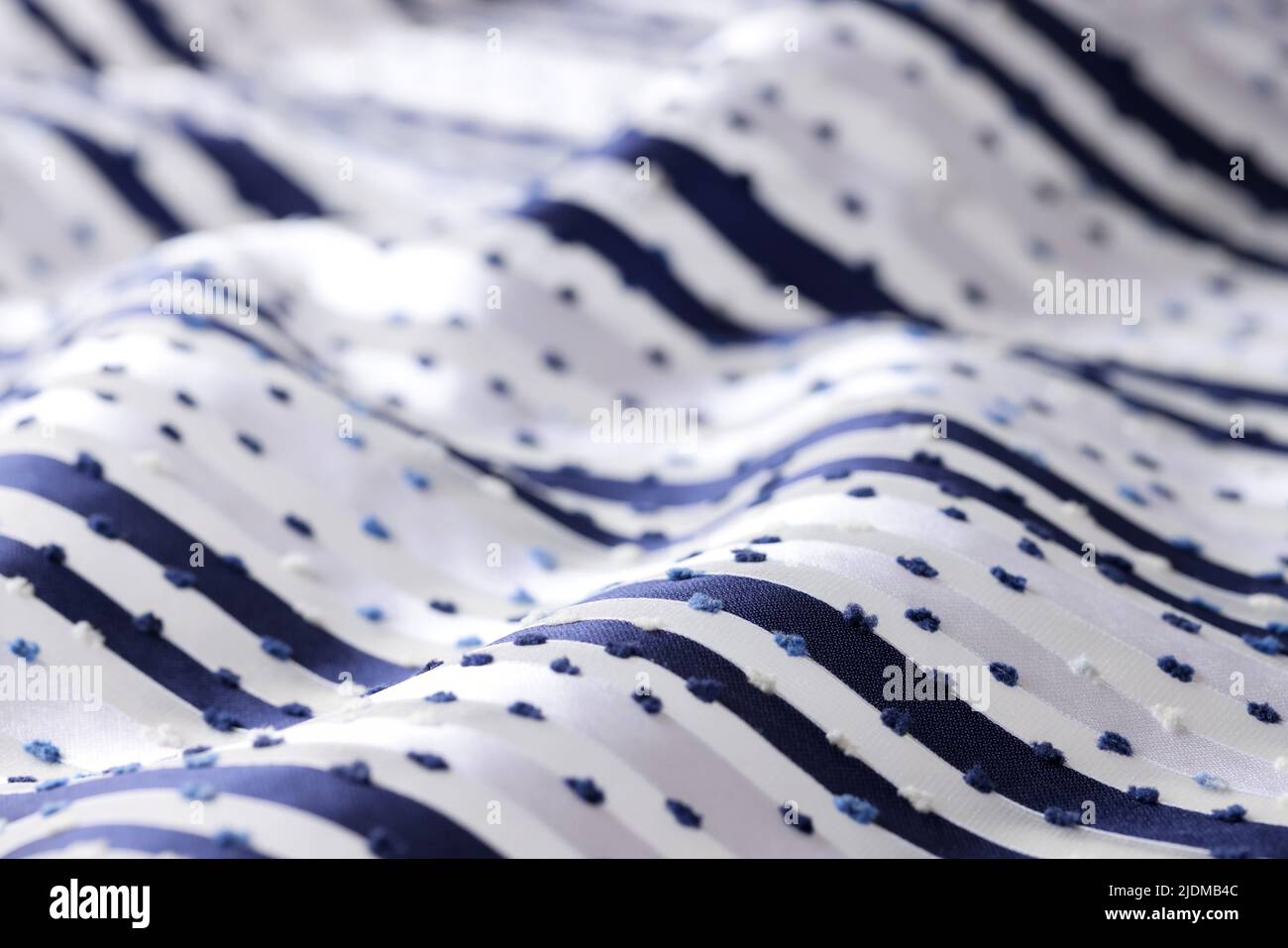 White fabric with dark stripes and dots Stock Photo
