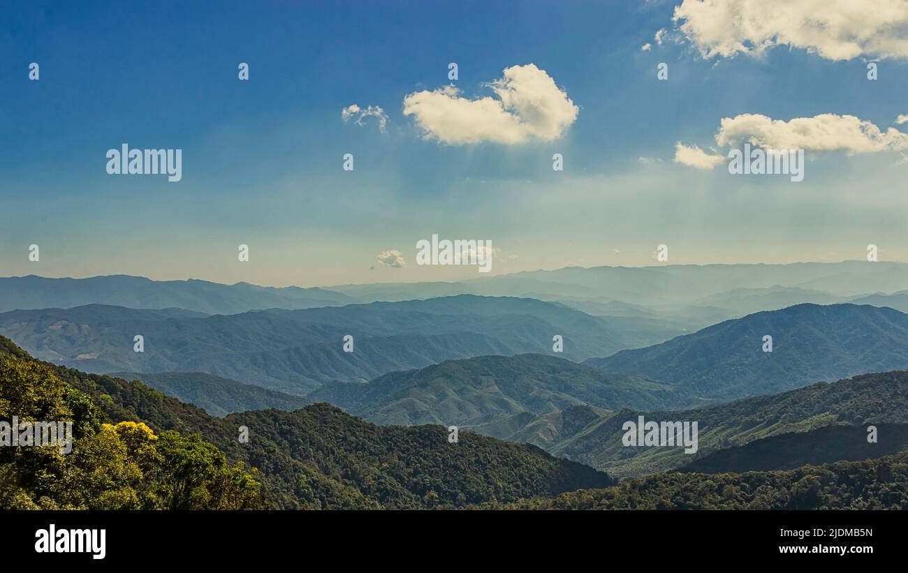 beautiful natural landscape mountain on the top view point above the rainforest, tropical evergreen forest with blue sky and white cloud Stock Photo