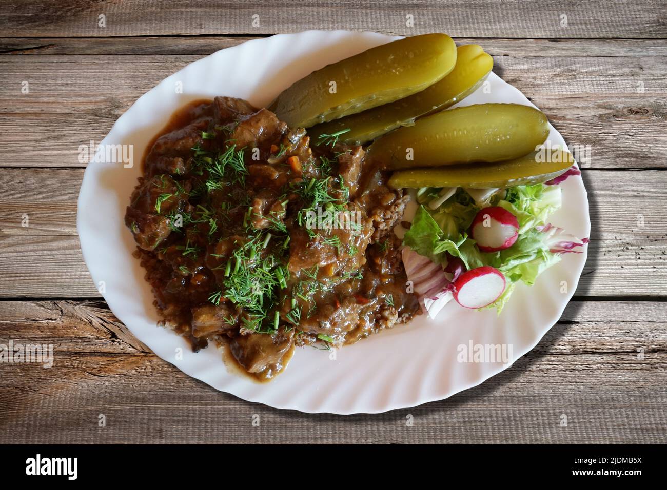 Goulash with buckwheat and pickles Stock Photo Alamy