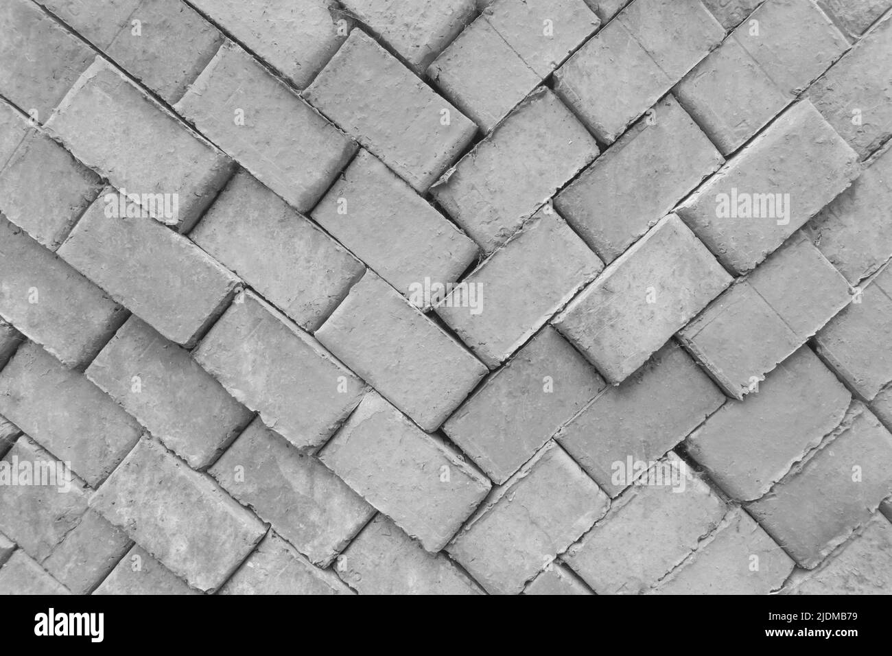 Brick grey old packed building stack construction material masonry pattern texture background. Stock Photo