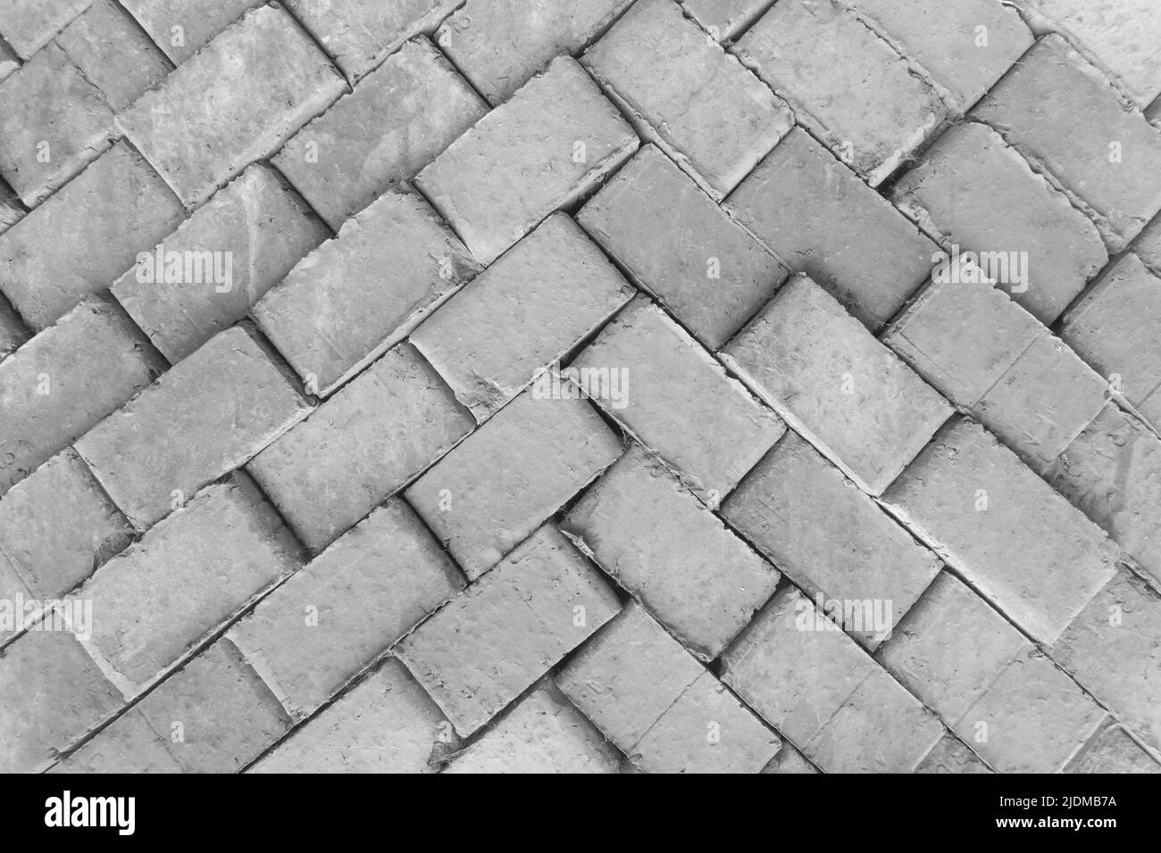 Brick grey old packed building stack construction material masonry pattern texture background. Stock Photo
