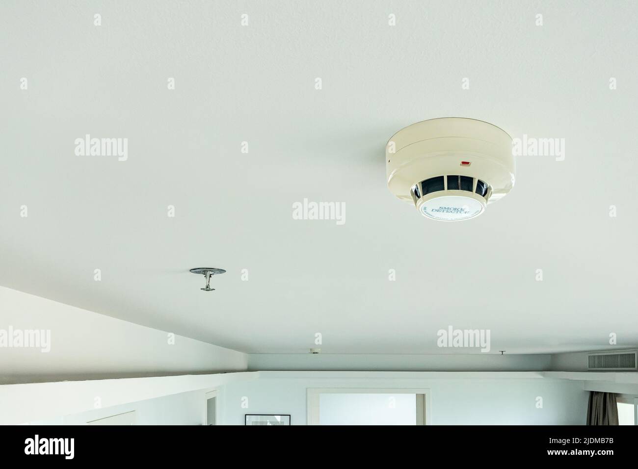 smoke detector and fire sprinkler on ceiling, fire alarming system and security system at home property for safety domestic life Stock Photo