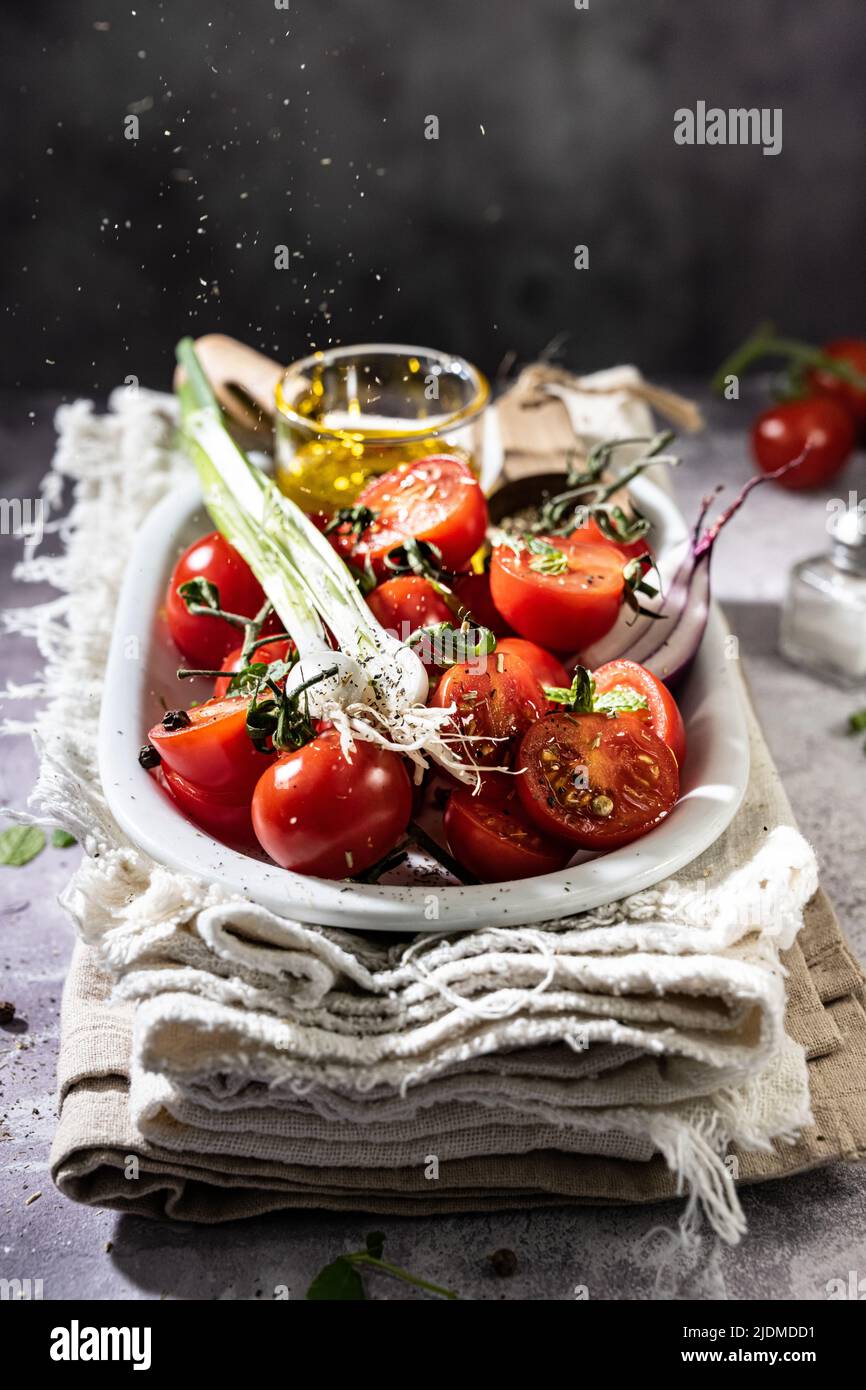 Healthy tomatoes salad with spice.Tomato with Spring onion and Oliver oil.Delicious food and drink Stock Photo