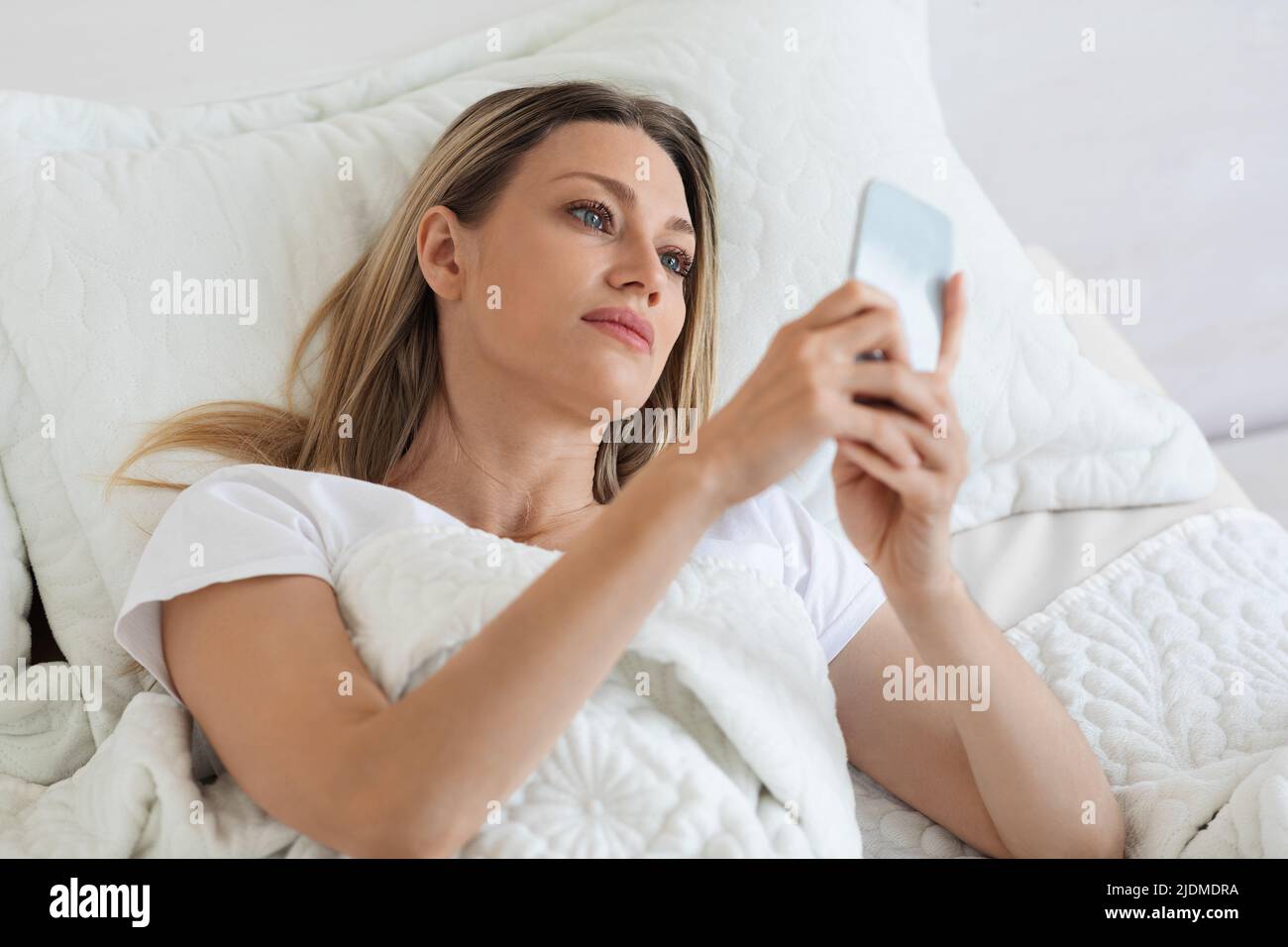 Beautiful Woman Laying In Bed With Smartphone Stock Photo Alamy Beautiful Woman Laying In Bed With Smartphone Stock Photo Alamy