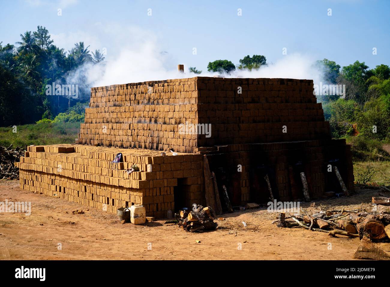 Drying and burning of bricks made of clay with fire wood, traditional