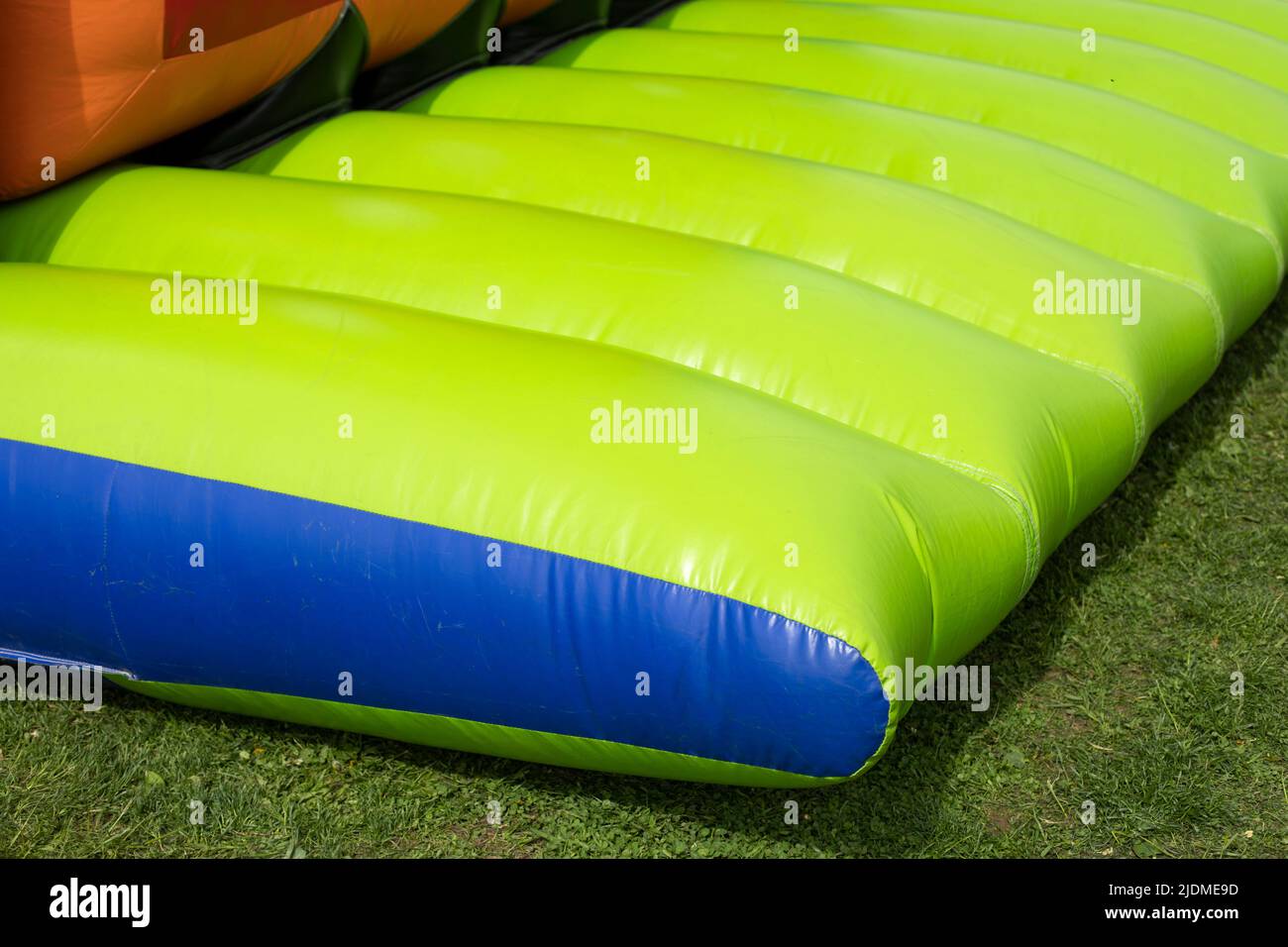 Green trampoline. Inflatable design. Details of amusement park
