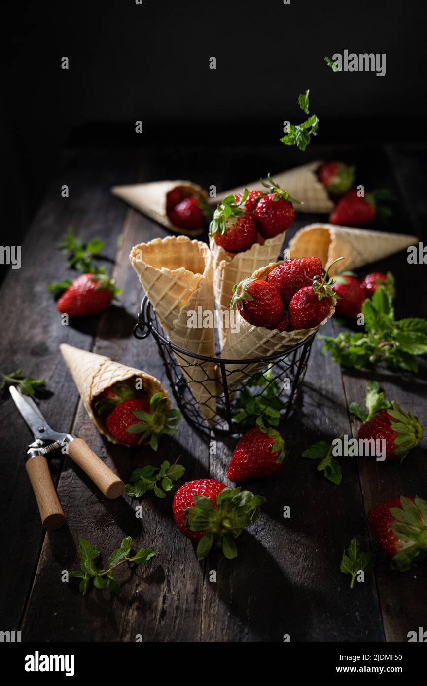 Fresh strawberries in wafers healthy dessert .Dark background. Summer snack. Stock Photo