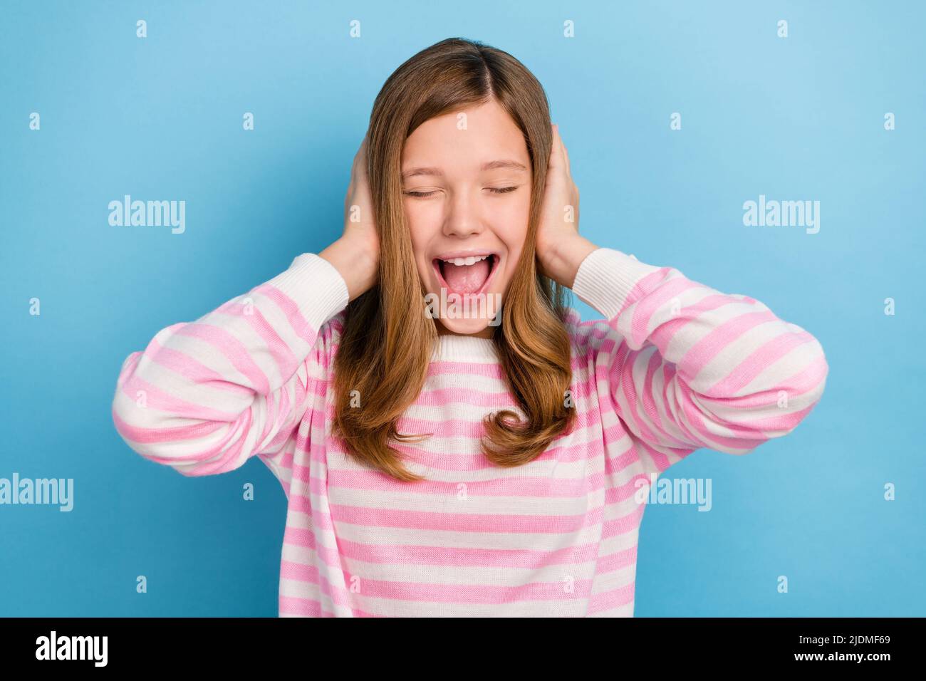 Photo of young girl closed eyes arms head ears open mouth shout isolated on blue color