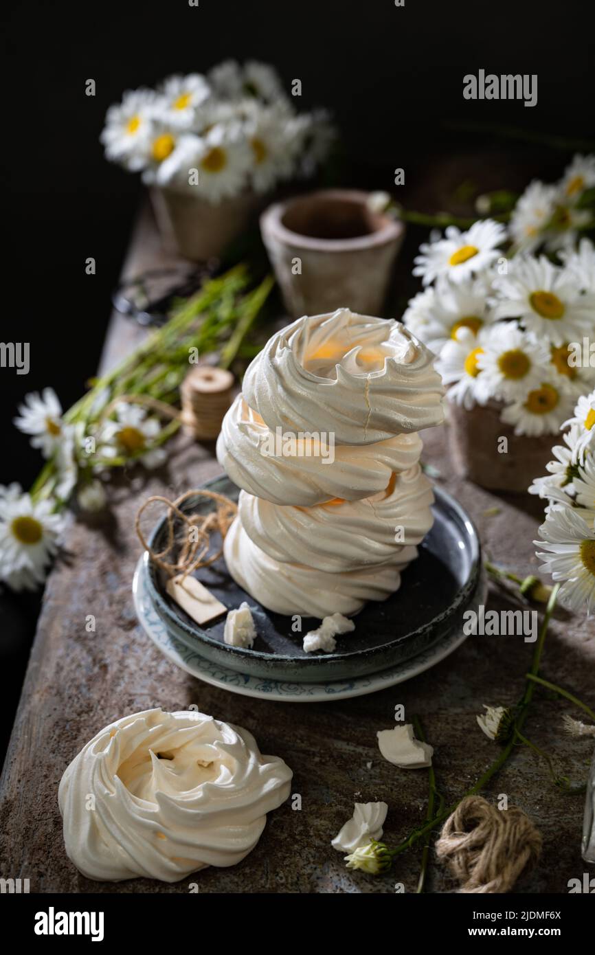 Summer and winter sweets meringues.Delicious food and drink.Dessert with flowers.Morning breakfast. Stock Photo