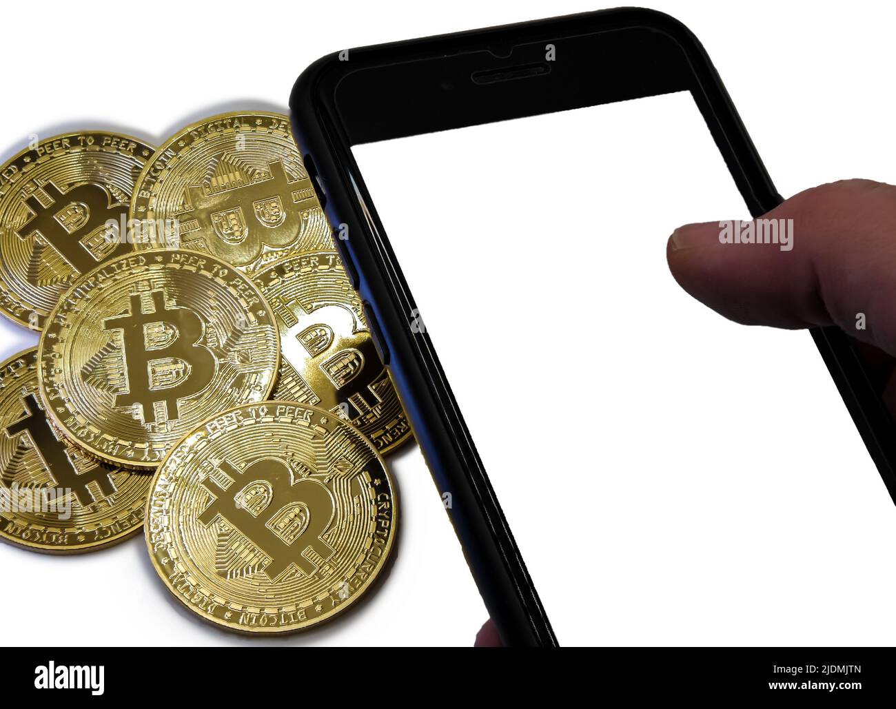 Bitcoin coins in golden metal with a man's hand beside him holding a smarthphone Stock Photo