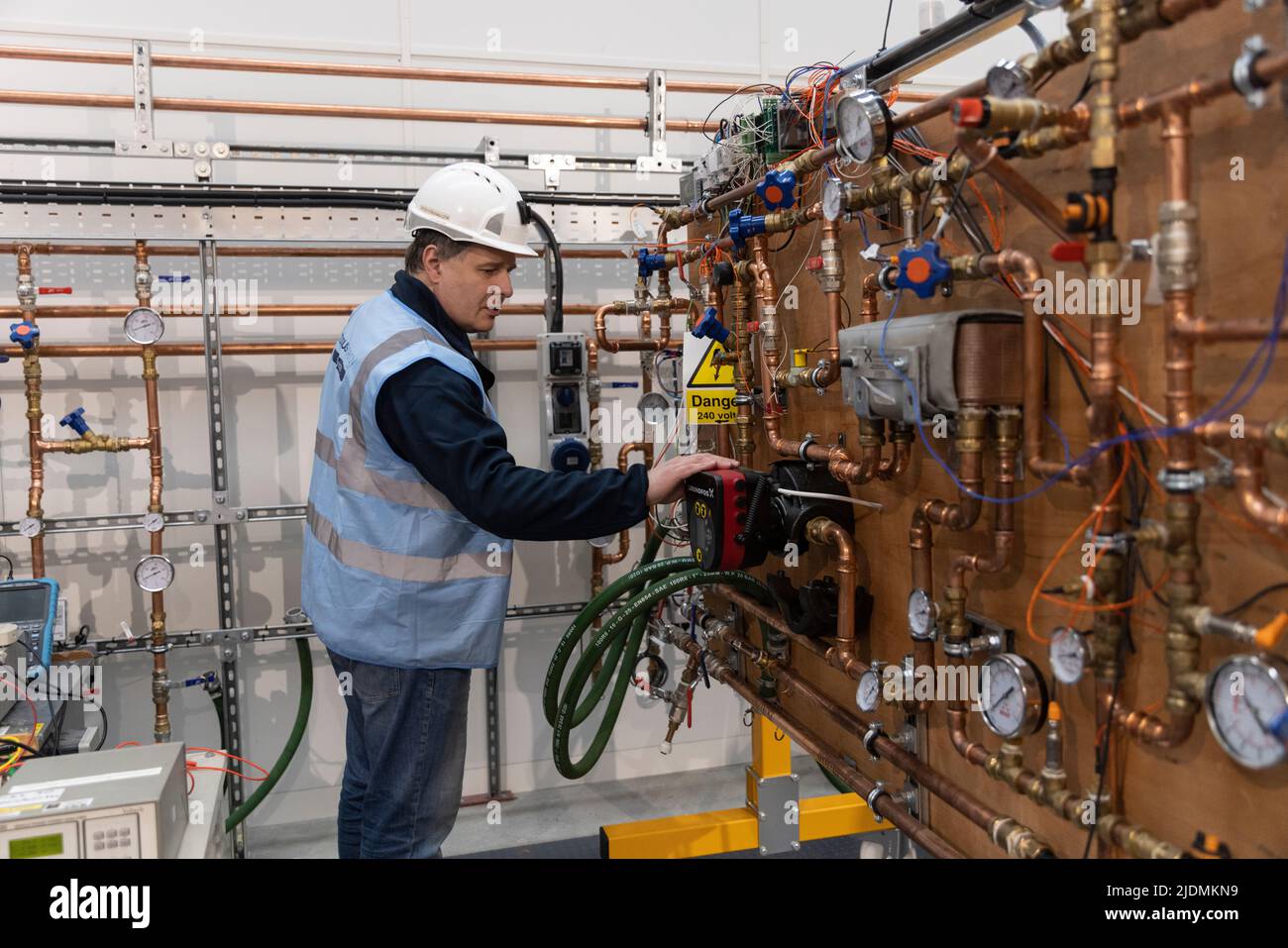 Heating engineer working on a testing board of heating apparatus at