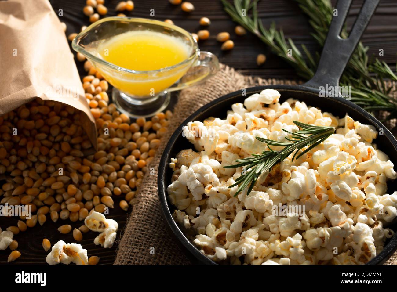 Popcorn in cast iron skillet with melted butter aside Stock Photo Alamy