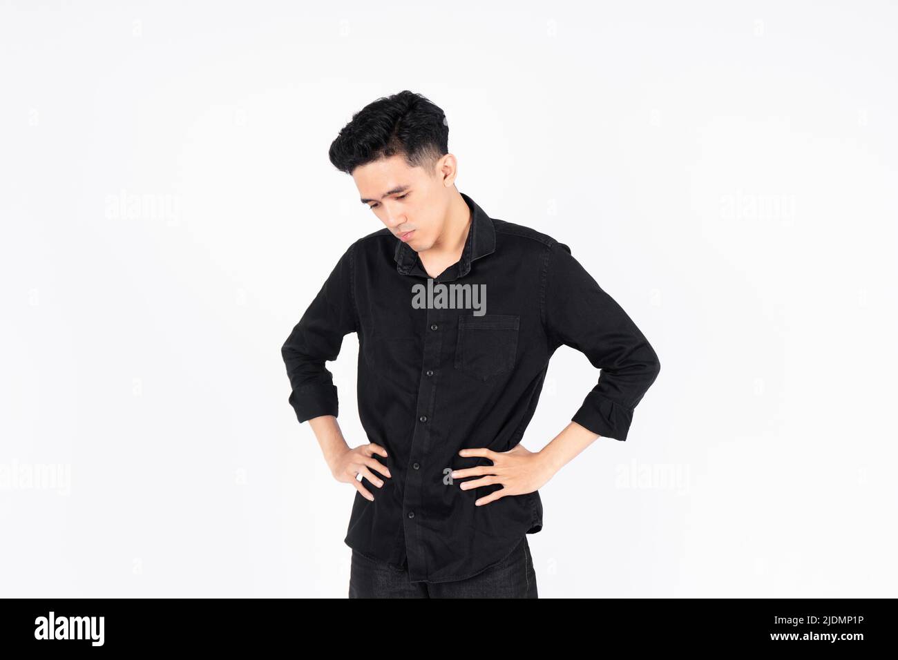 Young men show signs of disappointment with unsatisfactory work results or tired of what they are doing. with a black shirt on a white background. Stock Photo