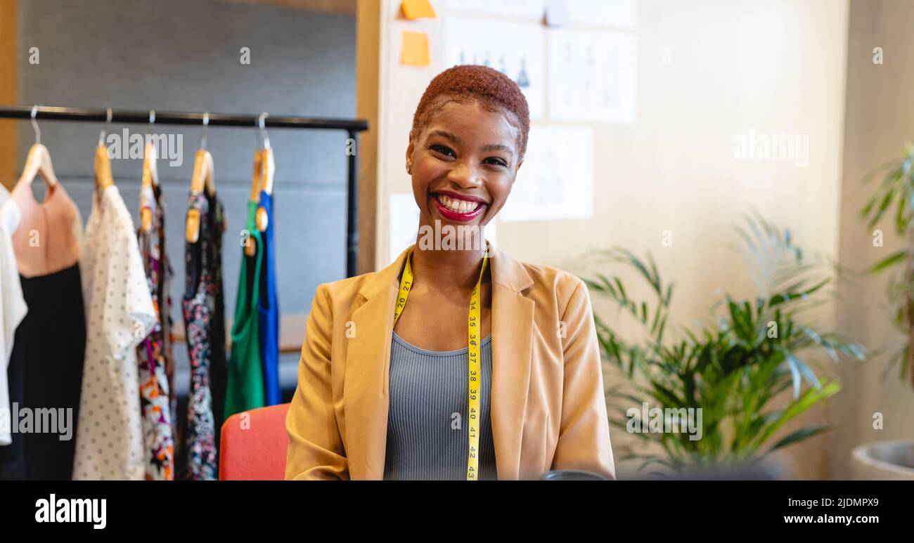 Portrait of smiling african american young female fashion designer with ...