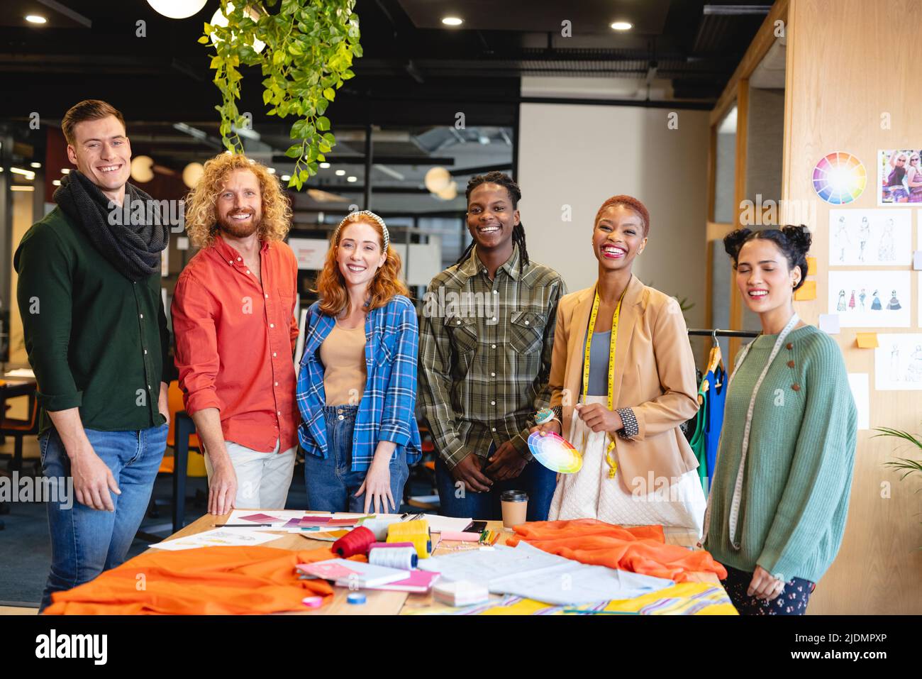 Portrait of smiling multiracial male and female fashion designers in ...