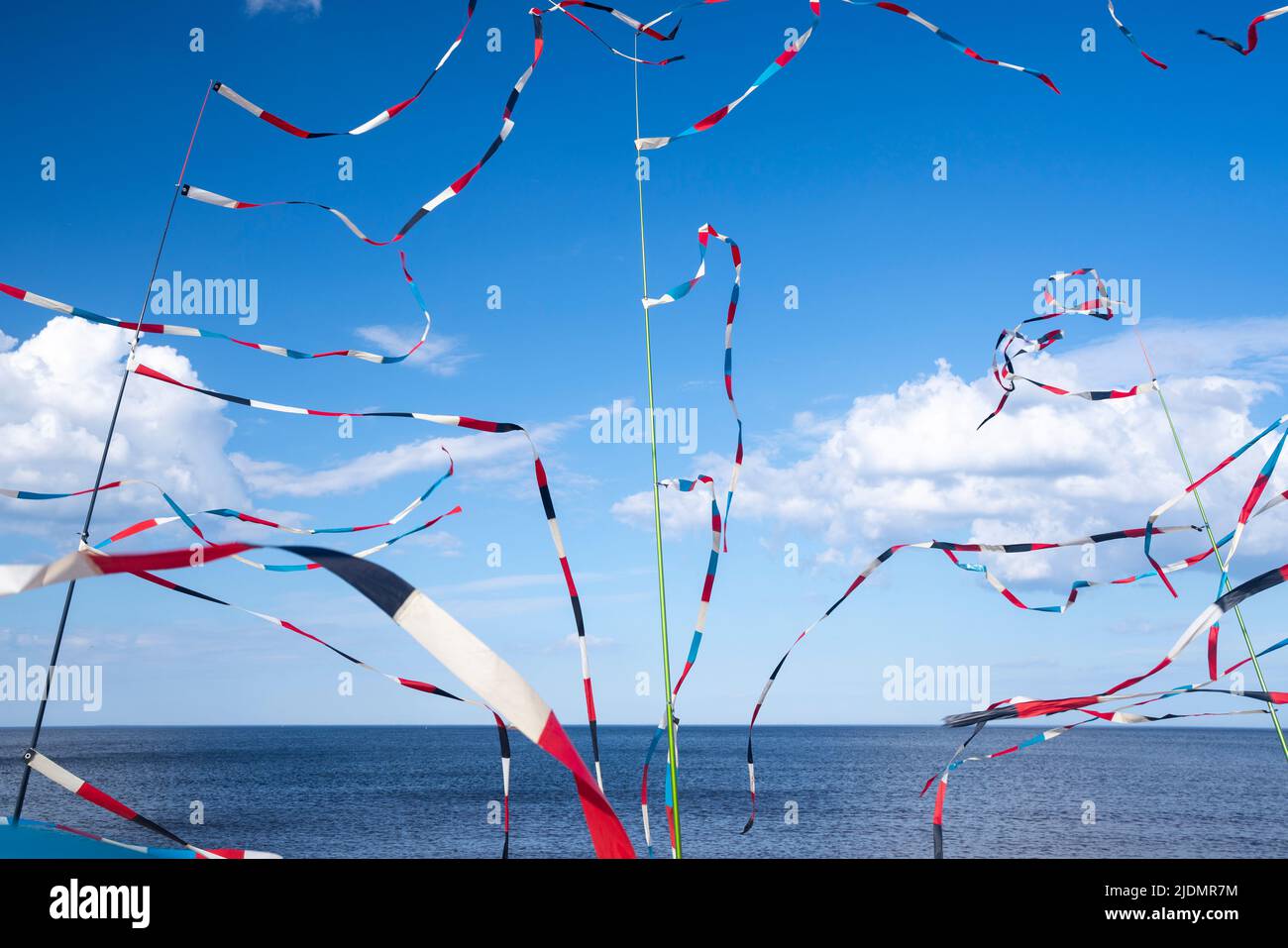 Colorful ribbons sway in the wind on the seashore. High quality photo ...