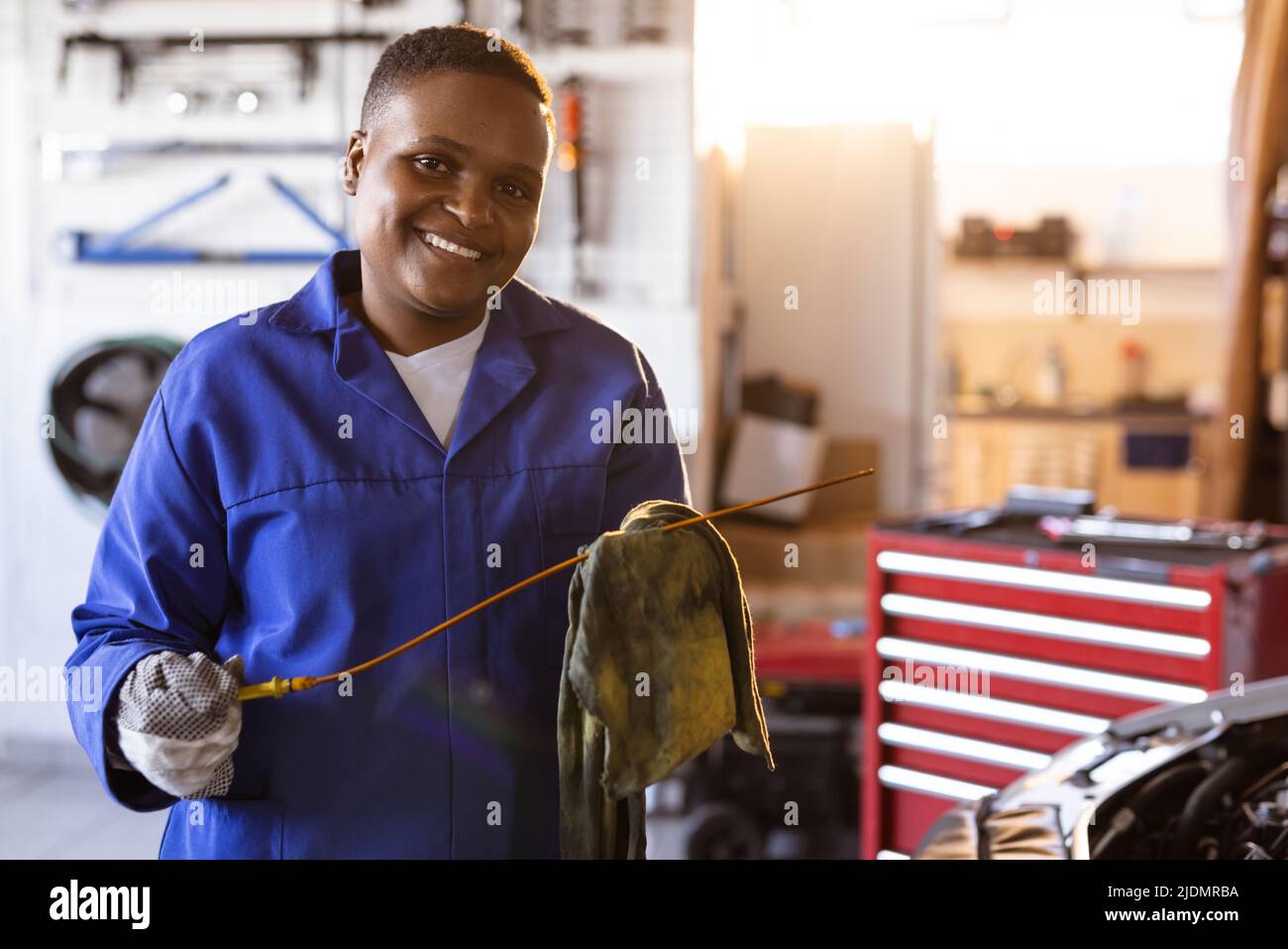 Portrait of smiling mid adult african american female mechanic working in workshop, copy space Stock Photo