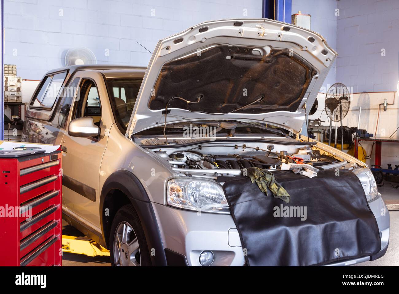 Image of faulty car with open bonnet for repair in workshop, copy space Stock Photo