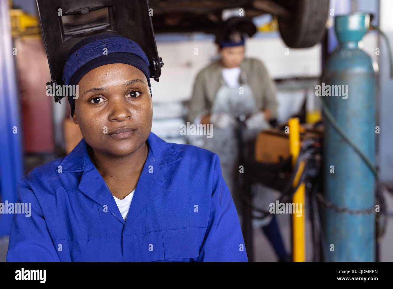Portrait of mid adult african american female welder wearing protective workwear in workshop Stock Photo