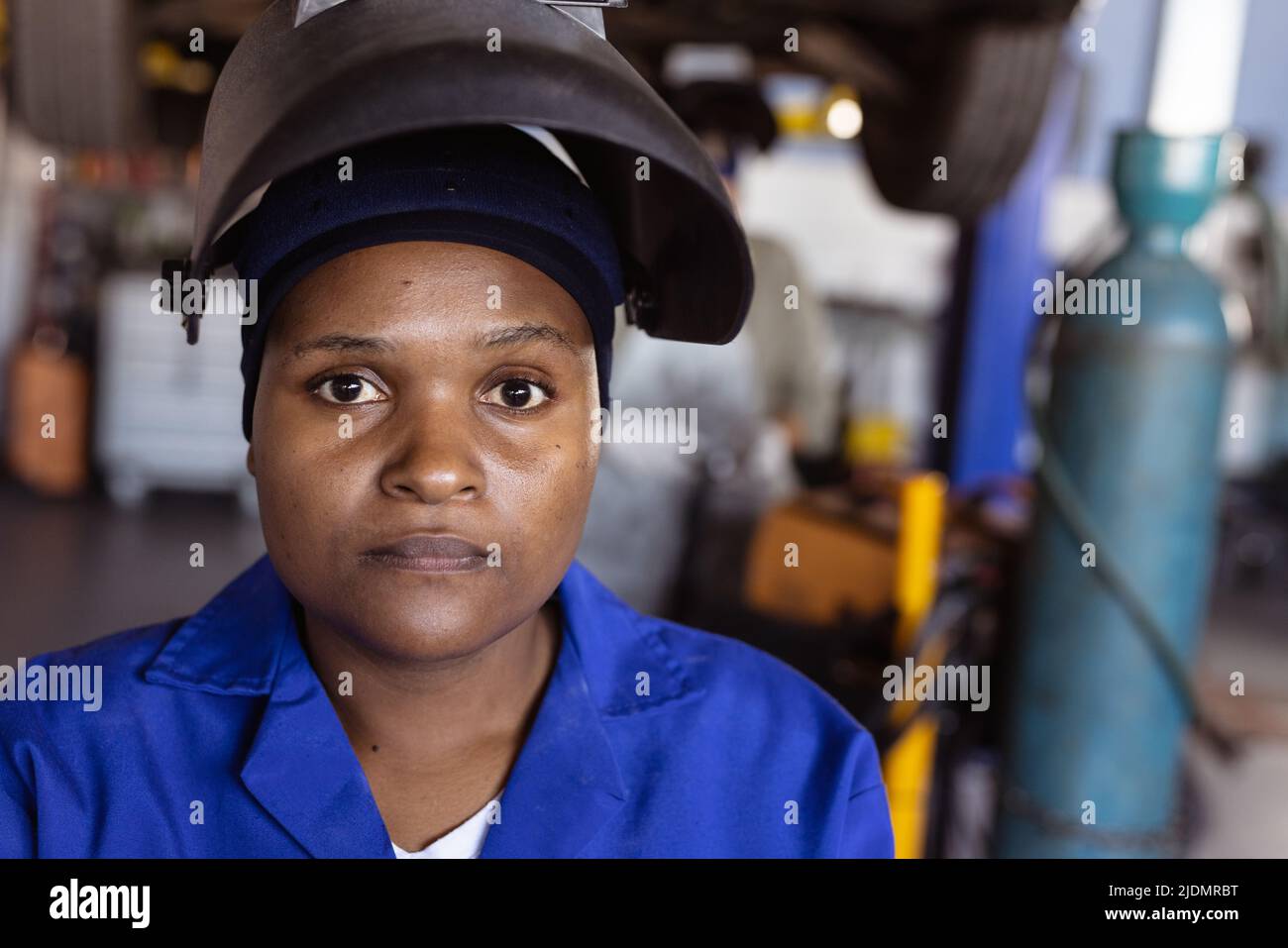 Close-up portrait of confident mid adult african american female welder in workshop Stock Photo