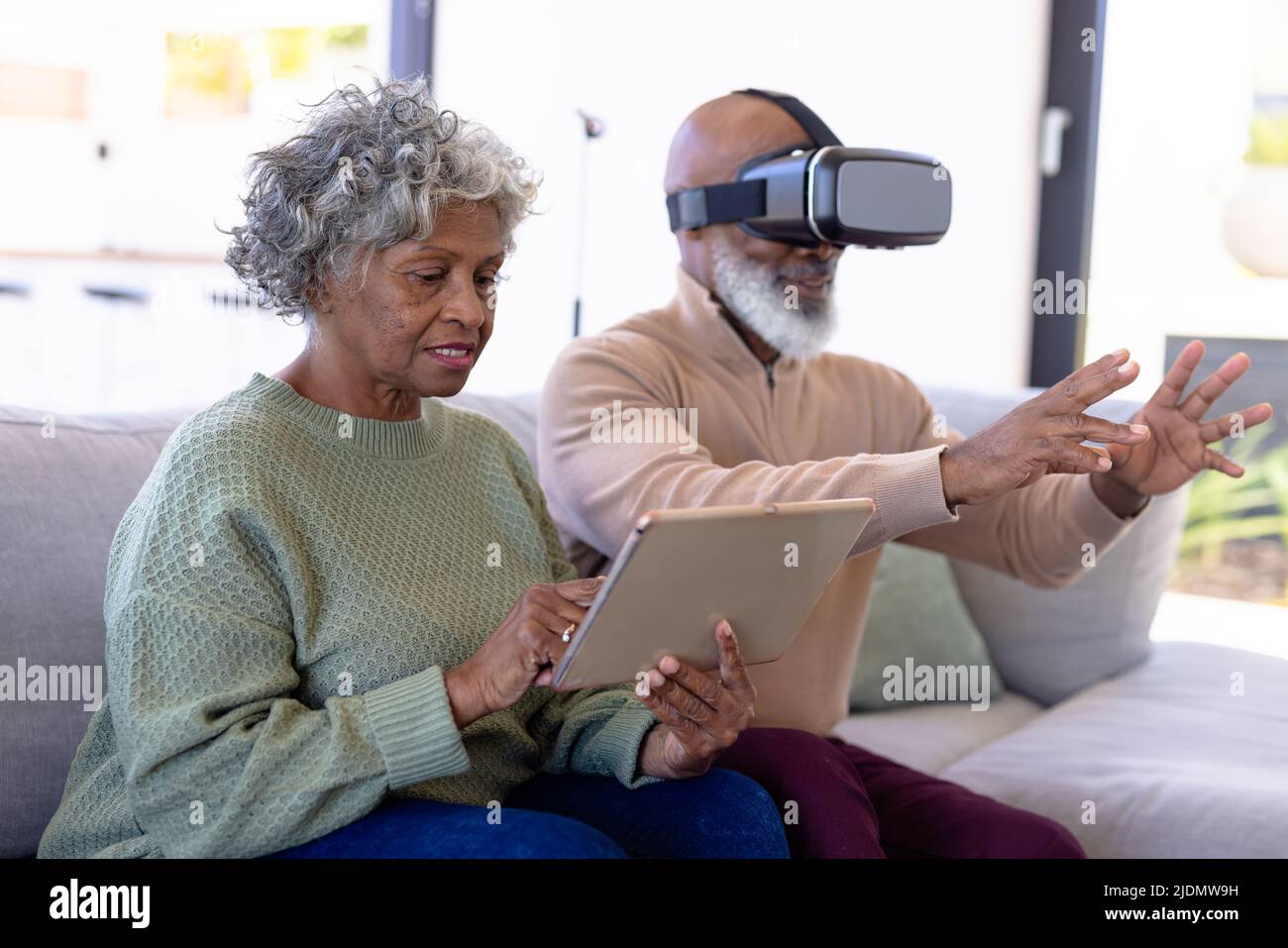 African american senior woman using digital pc and man using virtual ...