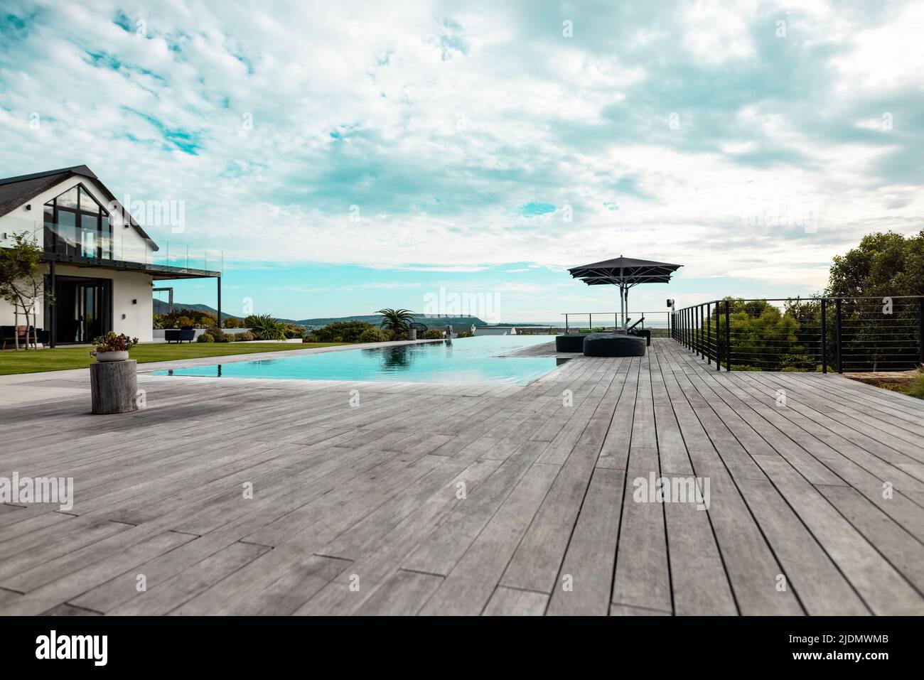Swimming pool and hardwood floor in front of nursing home against cloudy sky Stock Photo