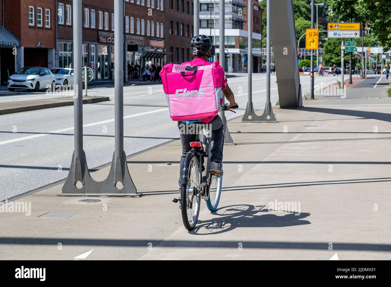 Flink on-demand delivery service courier on bike Stock Photo