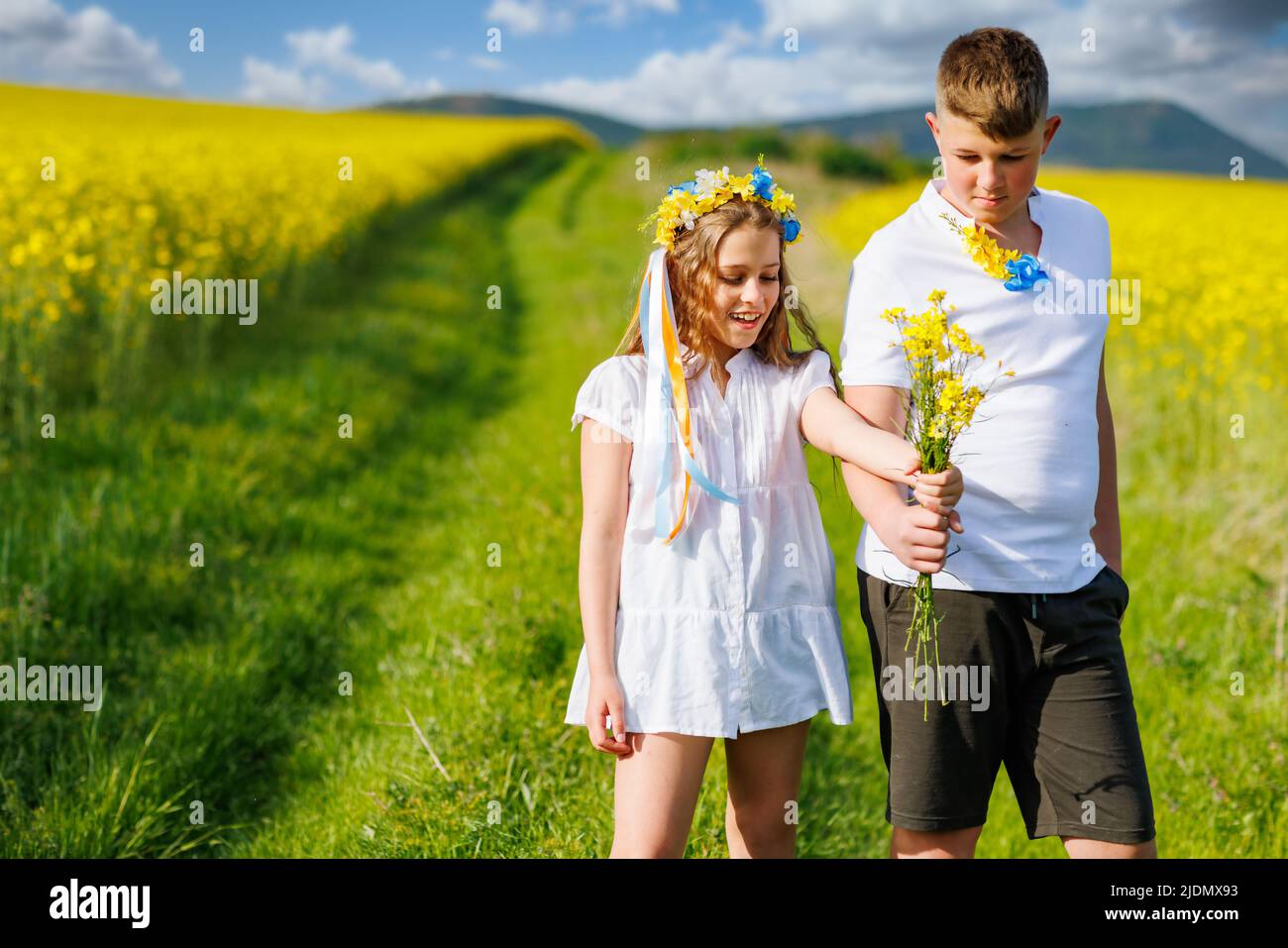 Front view of happy carefree native children: older teenage brother and ...