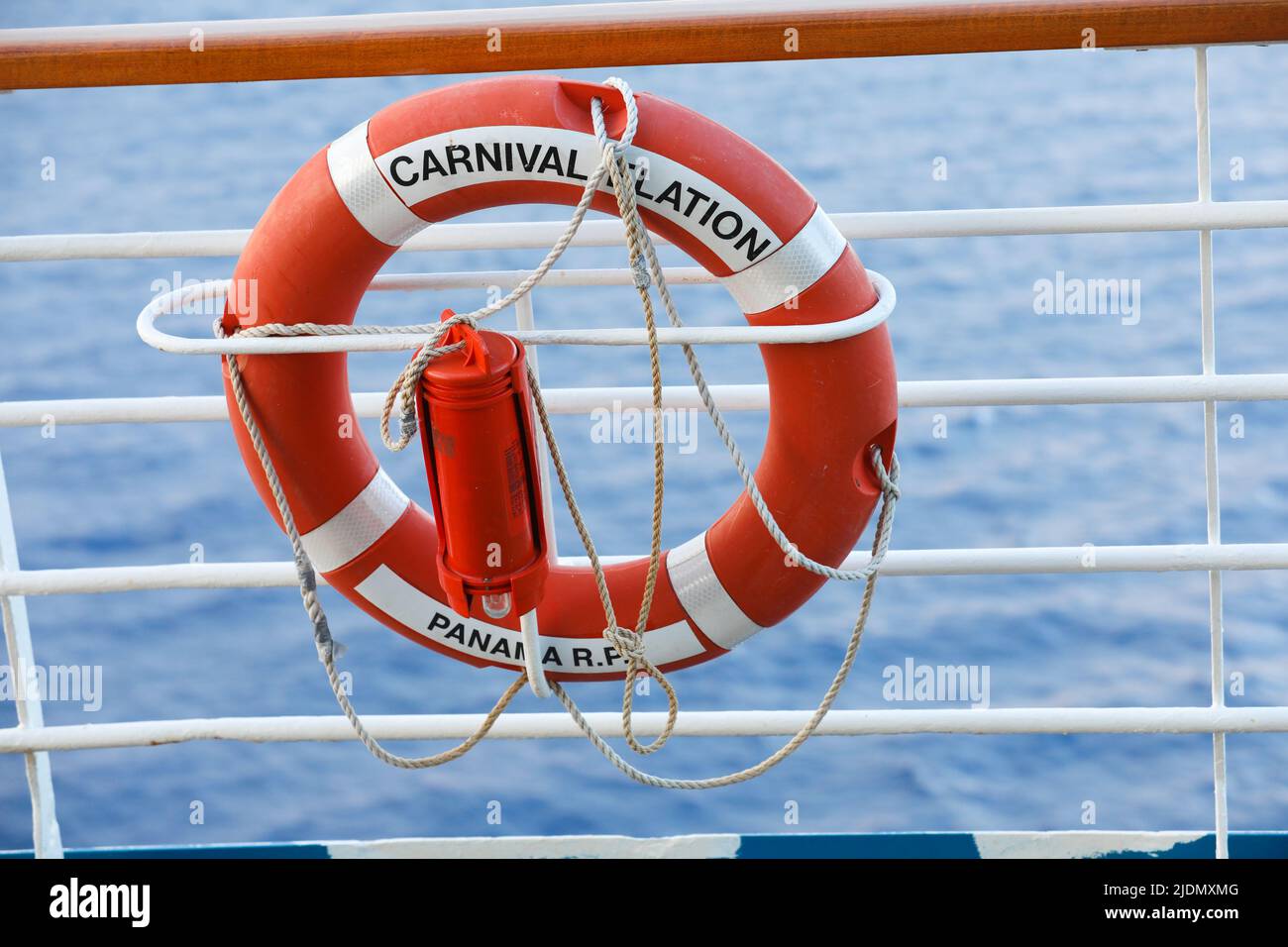 Lifebuoy or life ring orange on the ship with backdrop of the sea