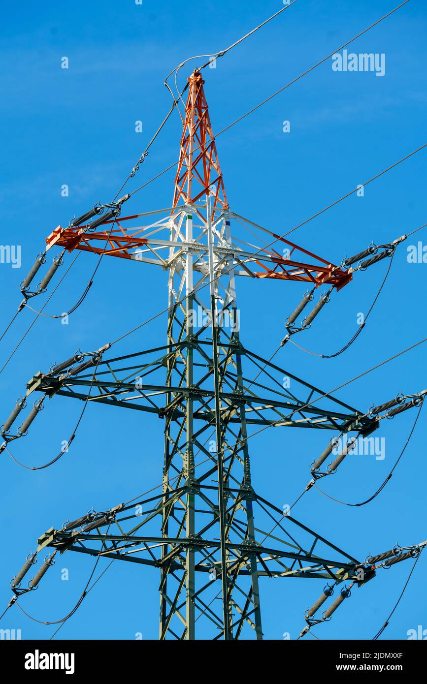 High voltage tower with electricity transmission power lines against ...