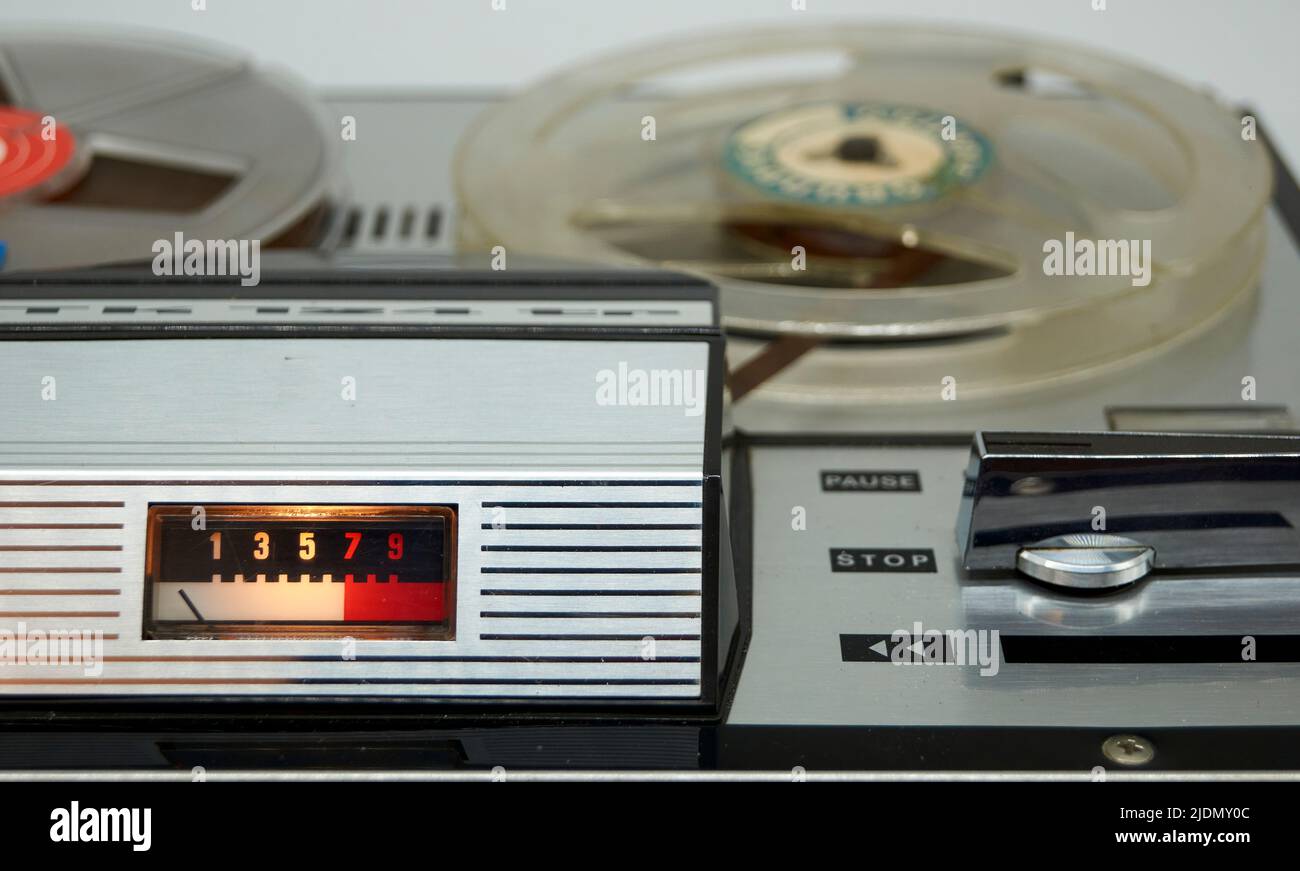 A vintage reeltoreel tape recorder with a vu meter and a large switch