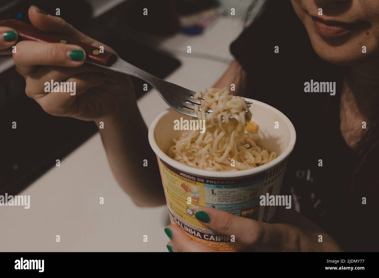 woman eating cup noodles Stock Photo Alamy