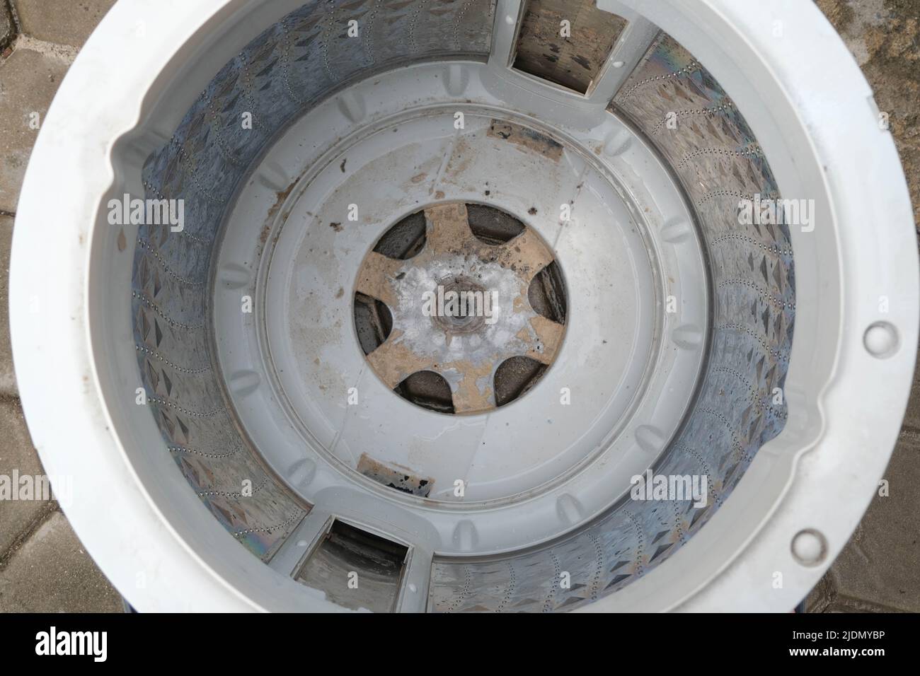 Inside of the washer drum is dirty stains, musty smell, household