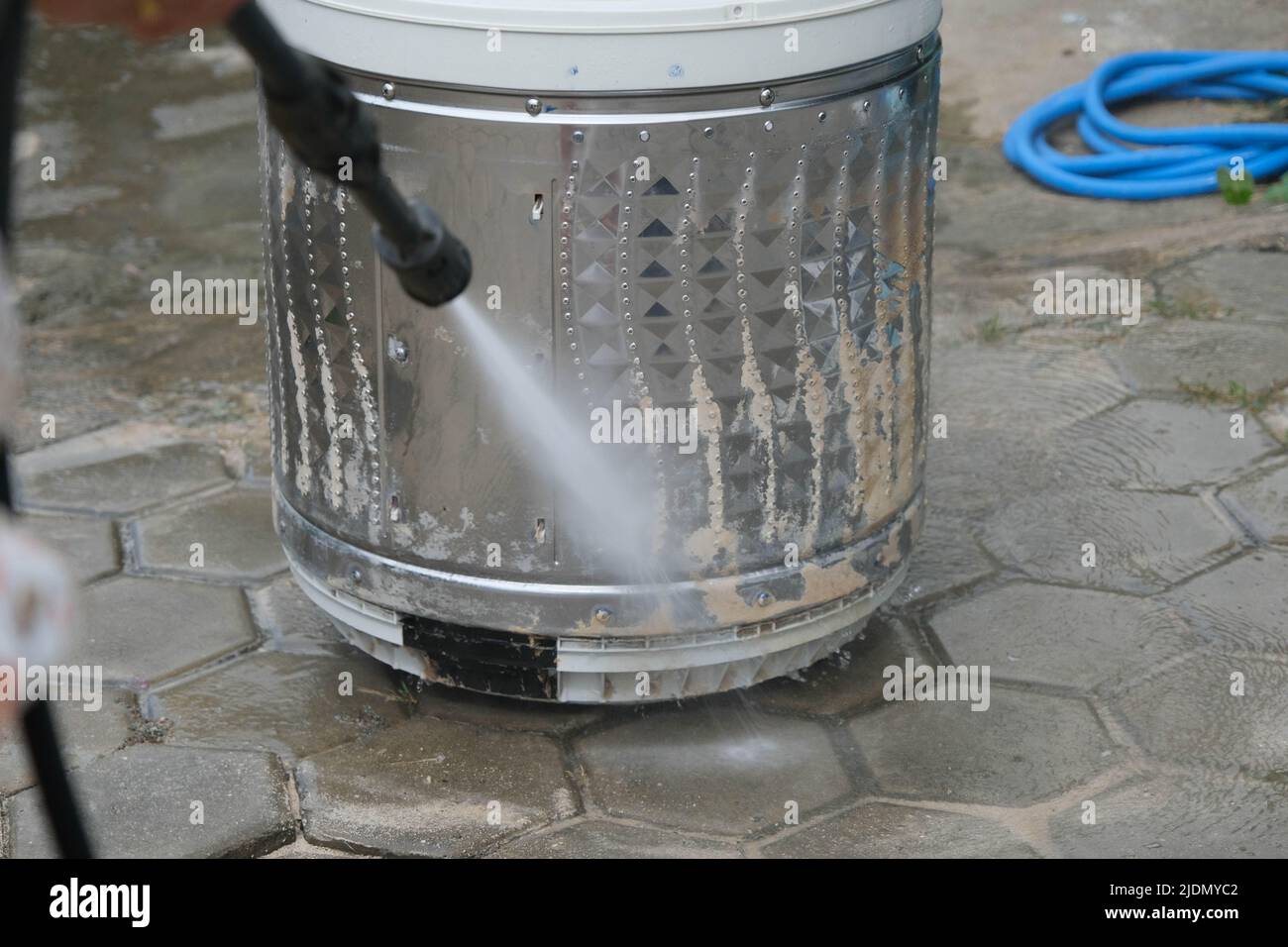 Closeup of washing machine drum descaling with highpressure cleaner
