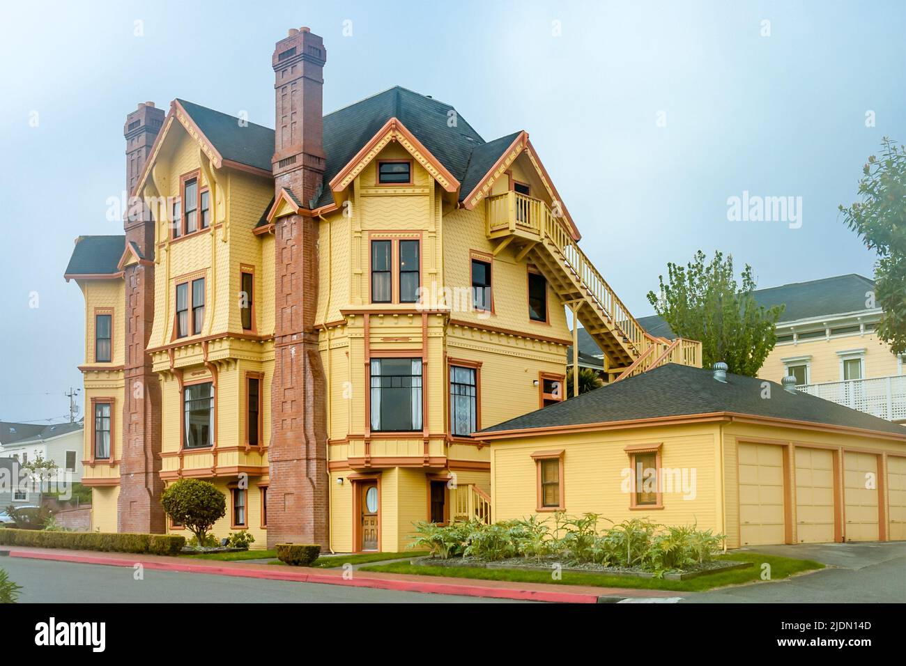 beautiful yellow mansion, Victorian style by a foggy day in Eureka
