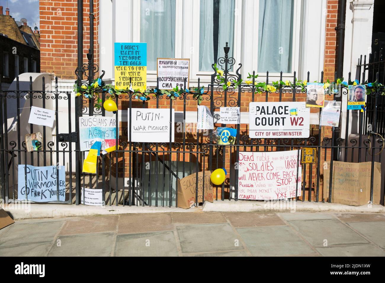 Placards and posters against President of Russia Vladimir Putin and its invasion of Ukraine are seen opposite the Russian Embassy in London. Stock Photo