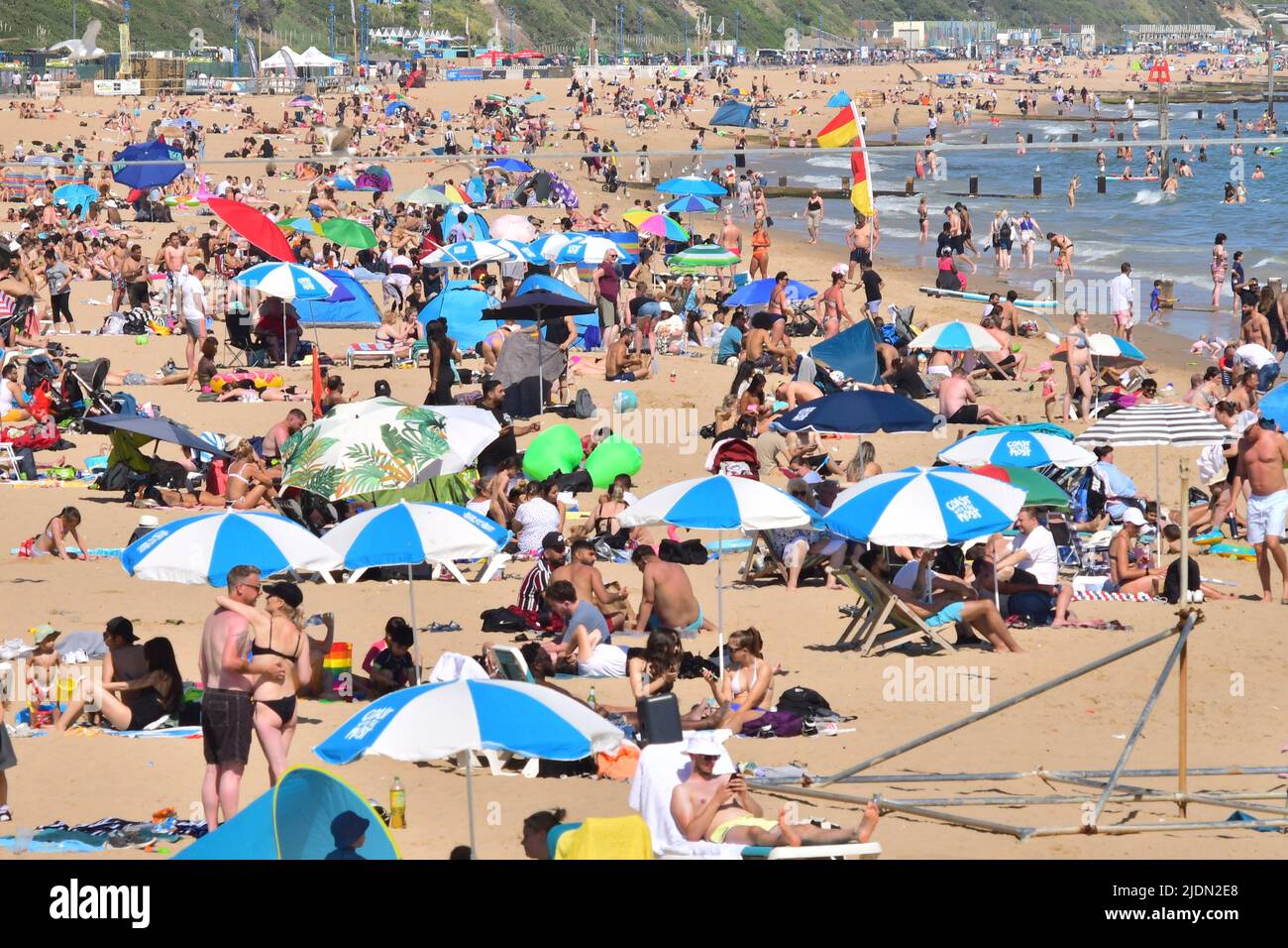 Bournemouth, Dorset, UK, 22nd June 2022, Weather. Hot afternoon in glorious summer sunshine. Busy beach with sun umbrellas. Credit: Paul Biggins/Alamy Live News Stock Photo