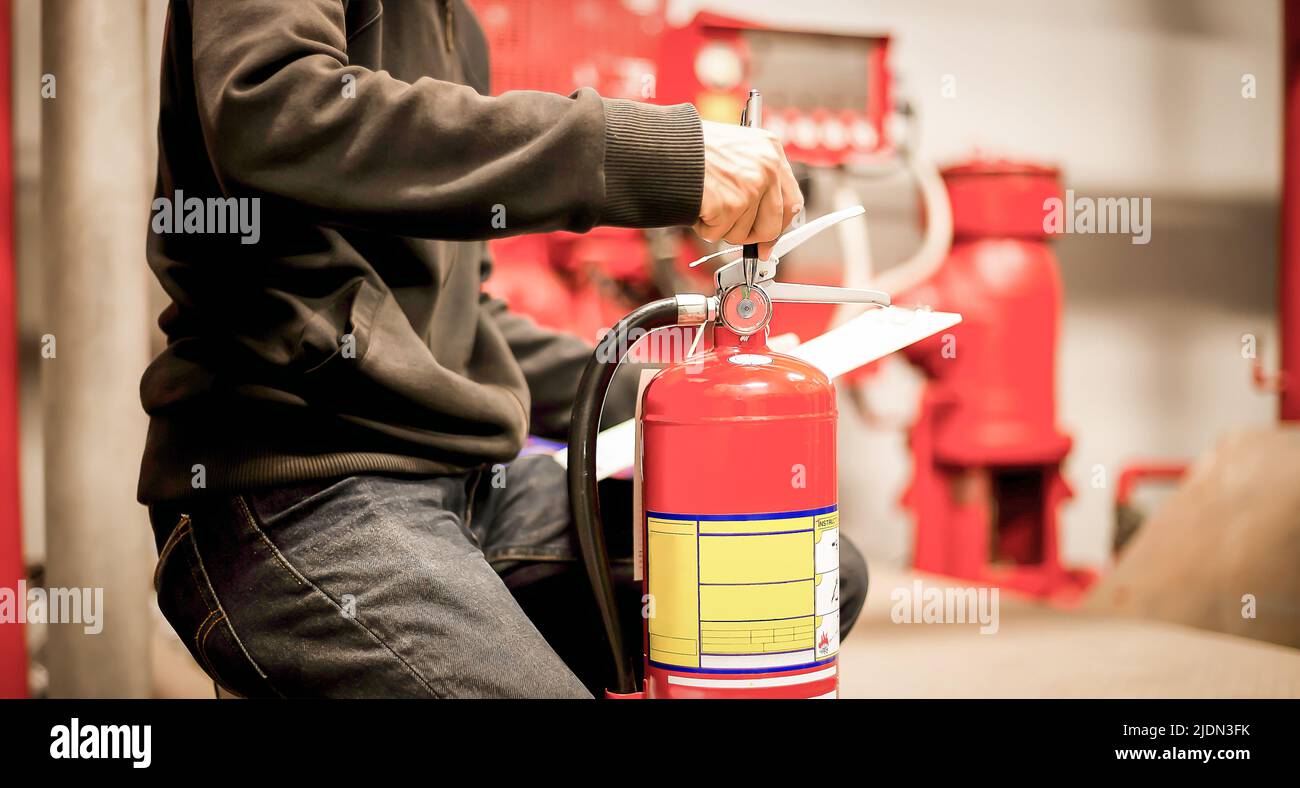 The red fire extinguisher is ready for use in case of an indoor fire