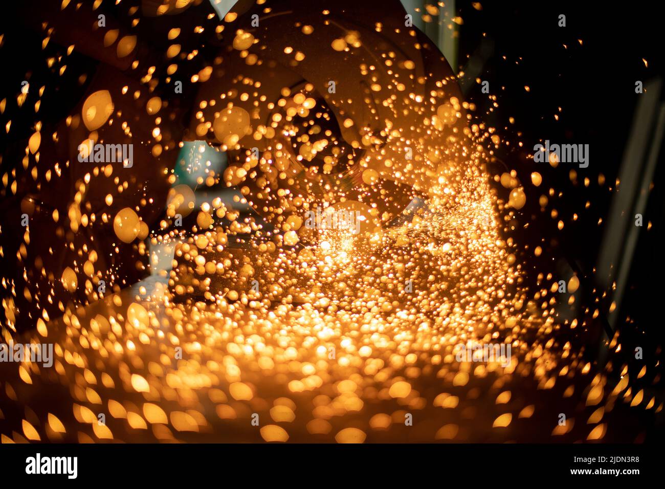 Sparks from grinder. Sawing steel. Industrial background. Texture of