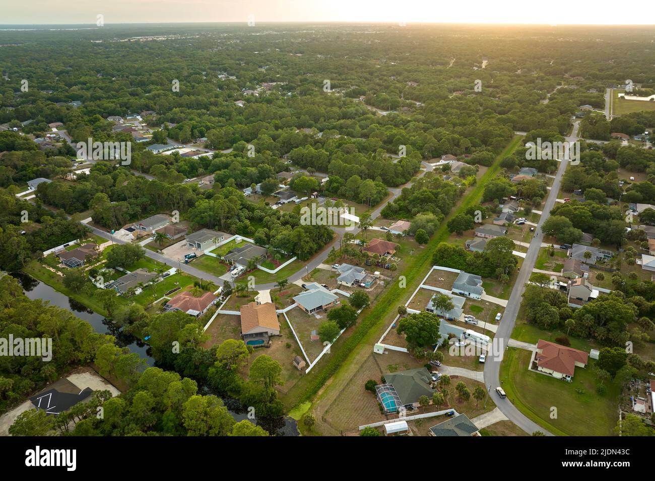 Aerial landscape view of suburban private houses between green palm