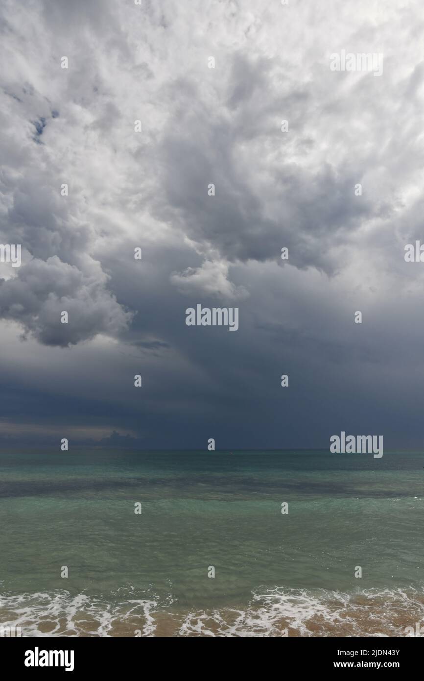 Stormy clouds over a sandy beach of Salento in Italy. Stock Photo