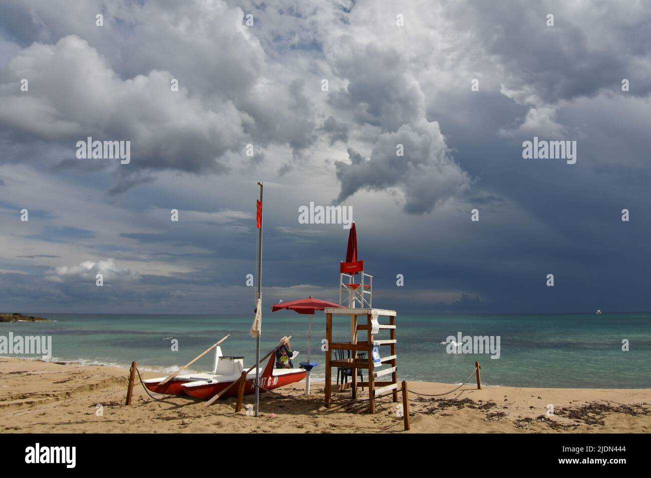 Stormy clouds over a sandy beach of Salento in Italy. Stock Photo