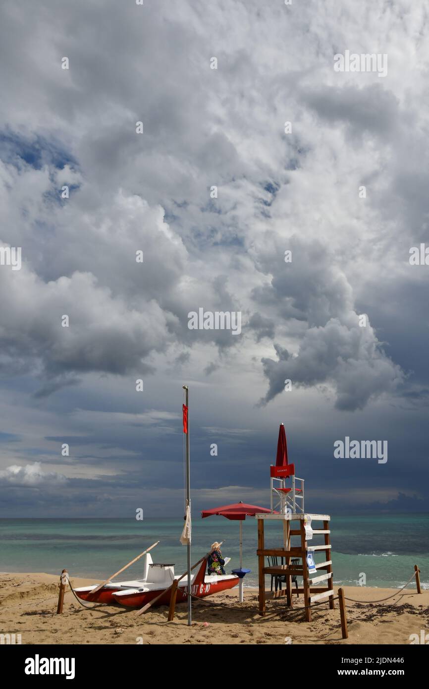 Stormy clouds over a sandy beach of Salento in Italy. Stock Photo