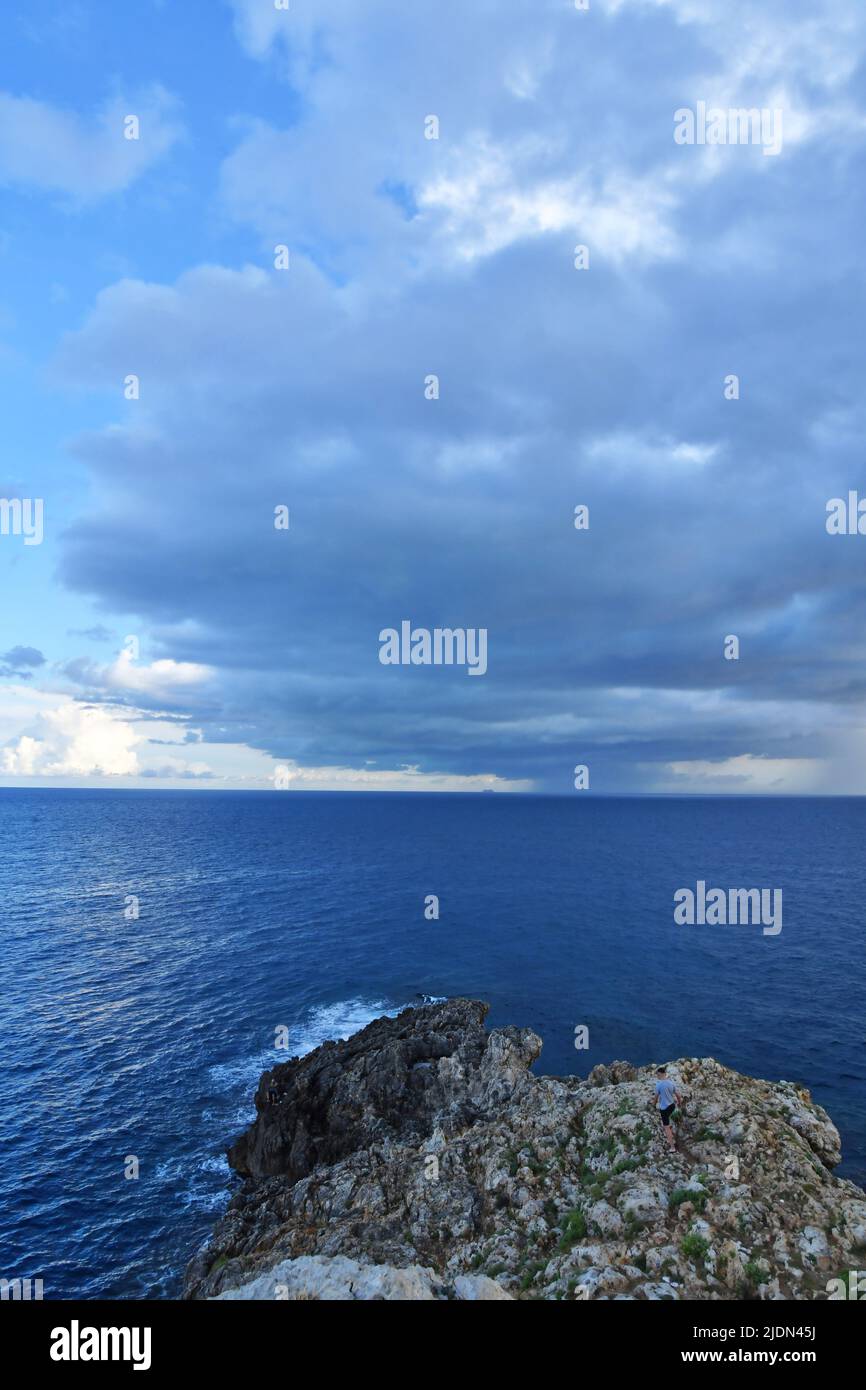 Stormy clouds over a sandy beach of Salento in Italy. Stock Photo