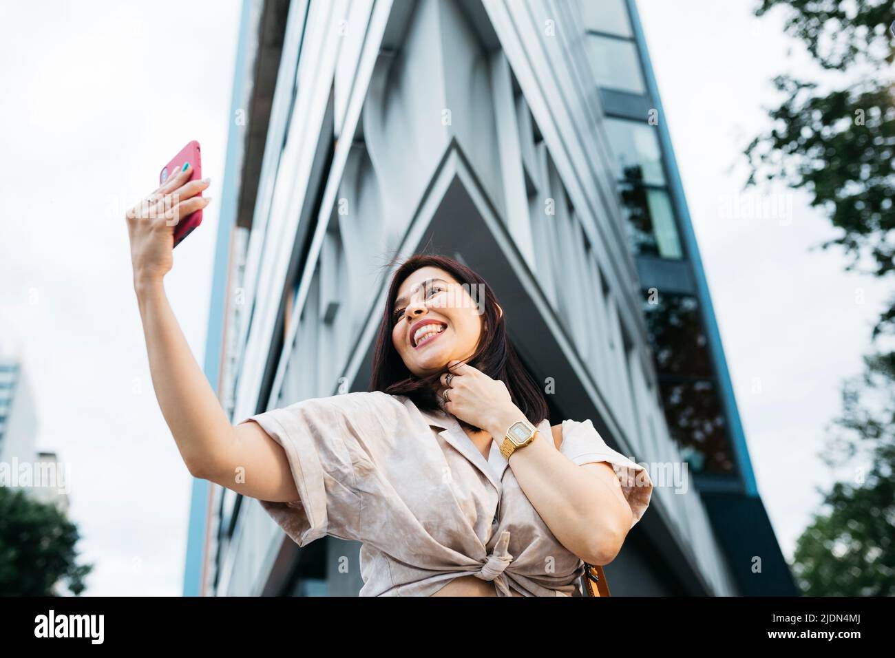 Young brunette woman taking a selfie on the street Stock Photo